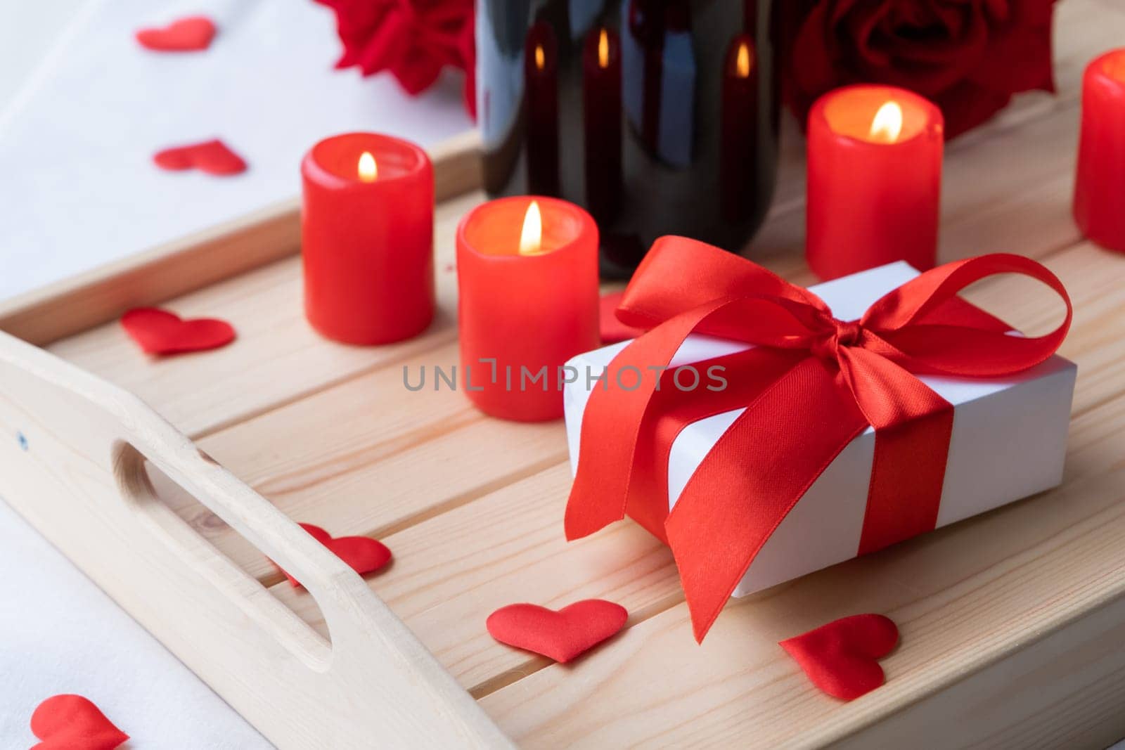 Valentines day. valentine gift box and candles in wooden tray