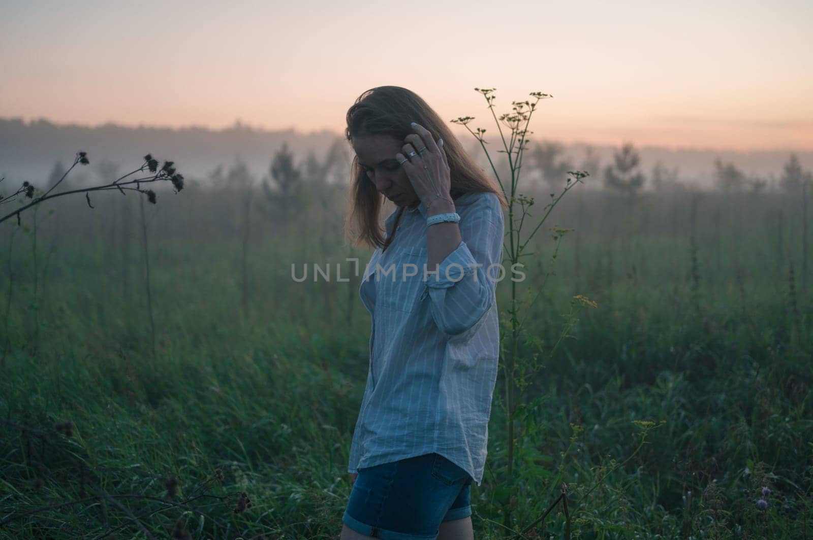 Woman in a field with misty fog