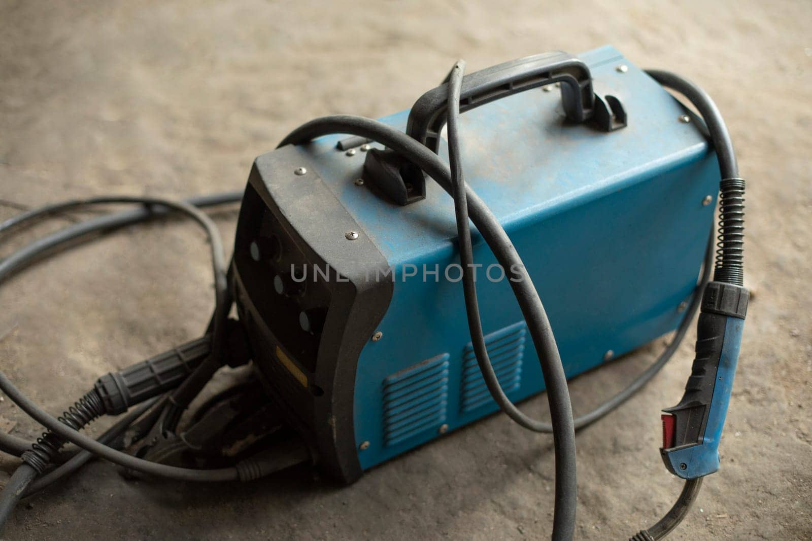 Electricity generator. Tools in garage. Battery storage. Charging wires.