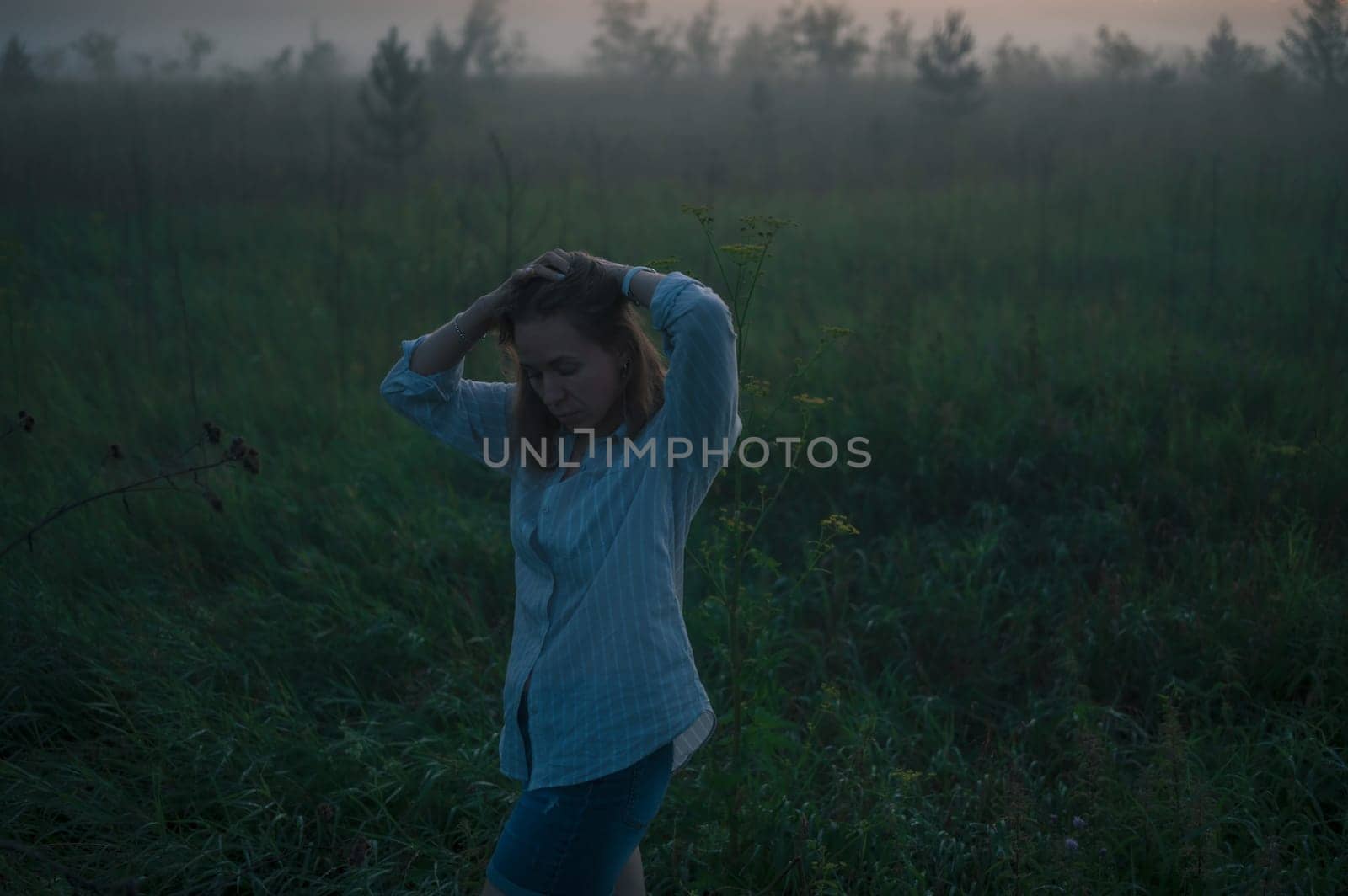 Woman in a field with misty fog