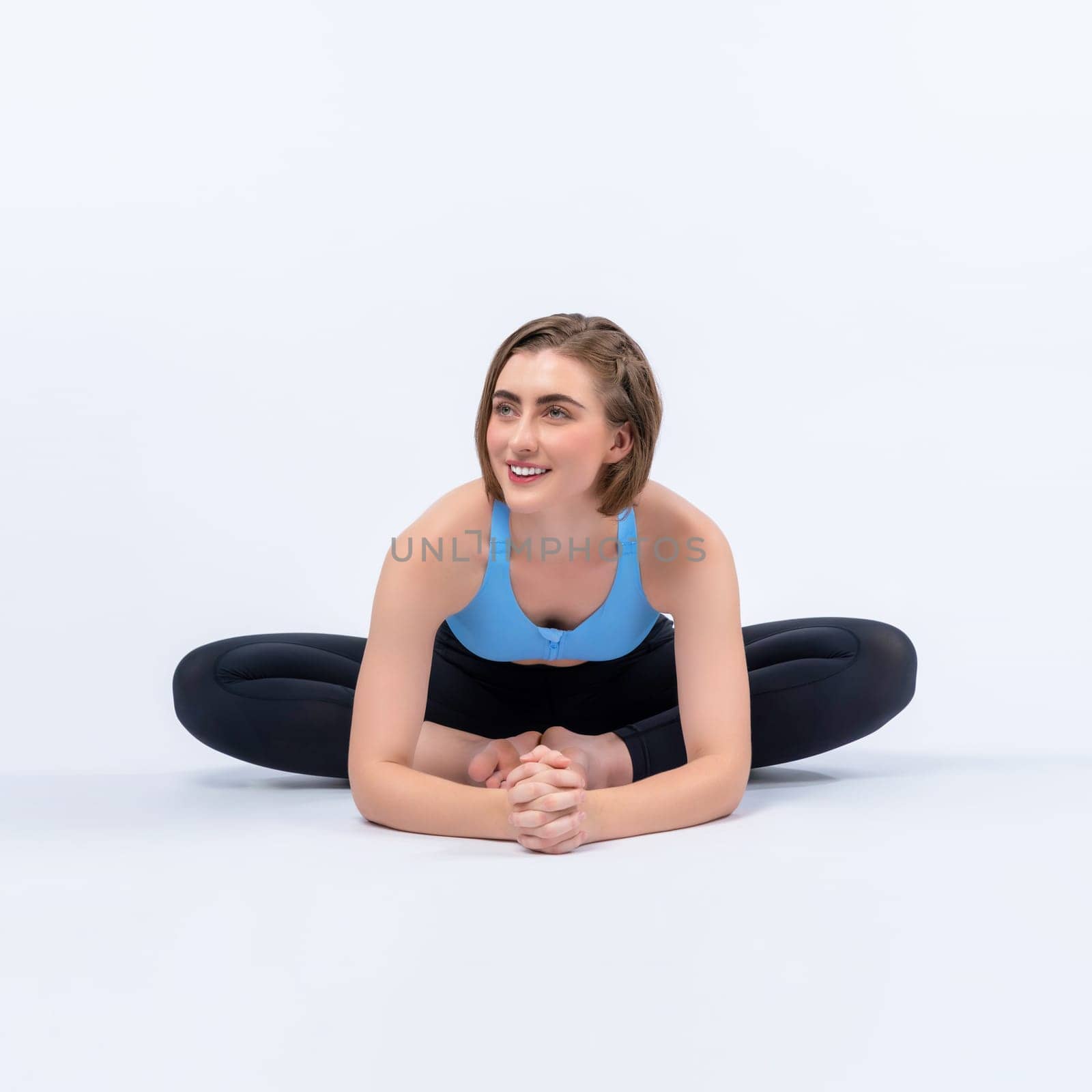 Full body length gaiety shot athletic and sporty woman doing yoga by biancoblue