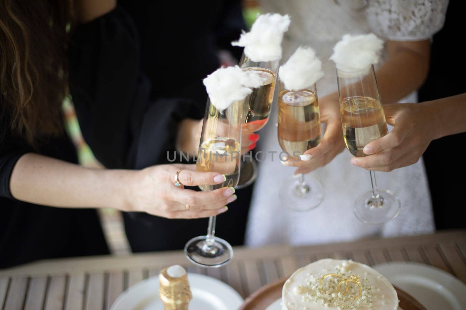 Girls hold glasses of wine. Party details. Wedding celebration. by OlegKopyov