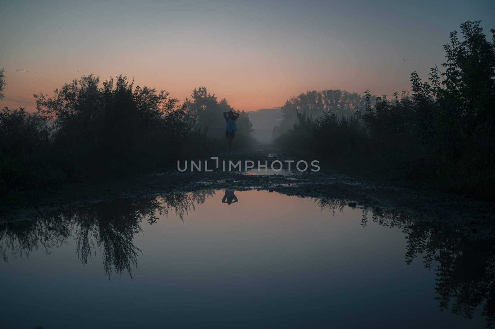 Woman in beautiful misty fog, summer landscape