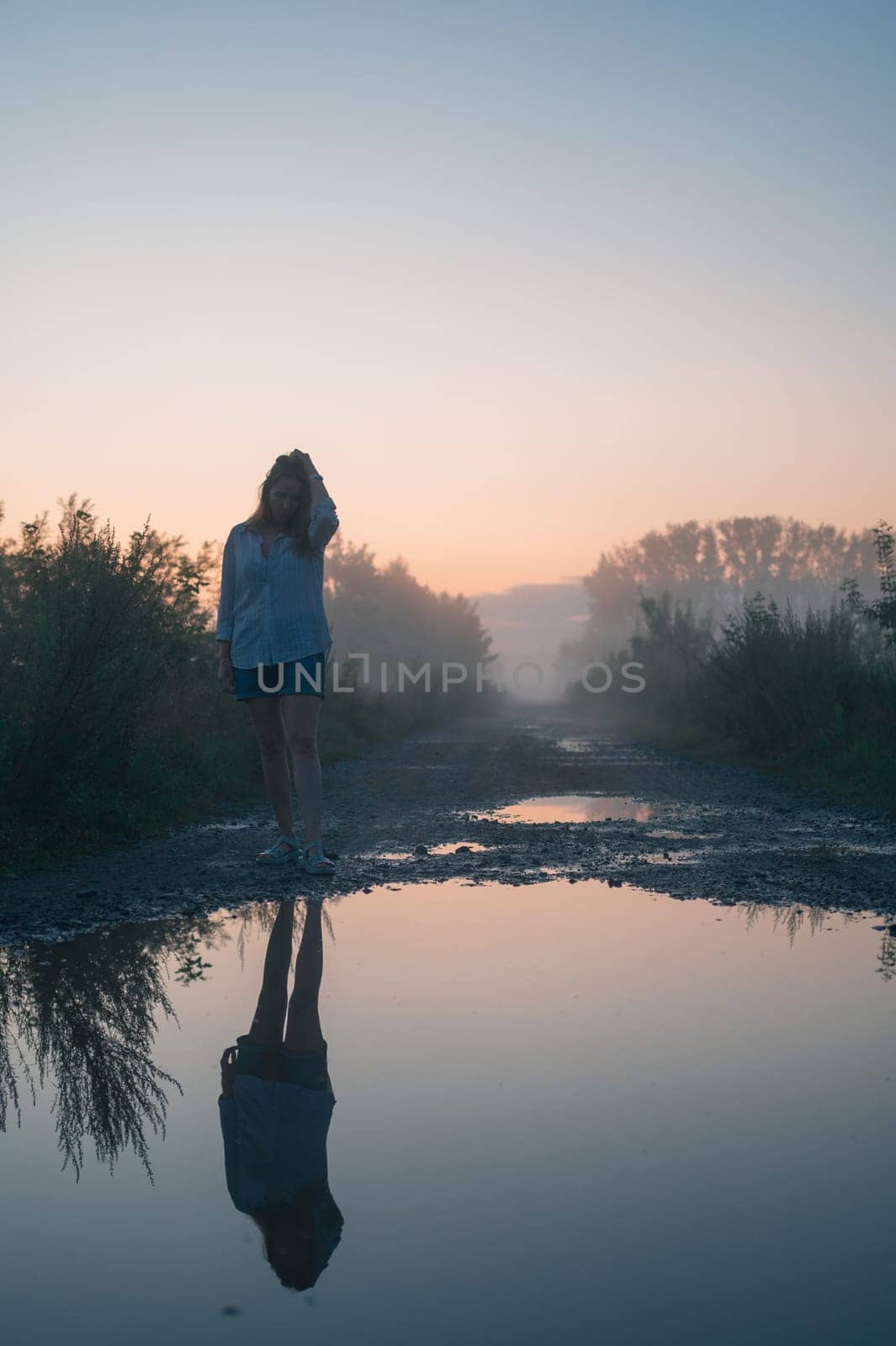 Woman in beautiful misty fog, summer landscape