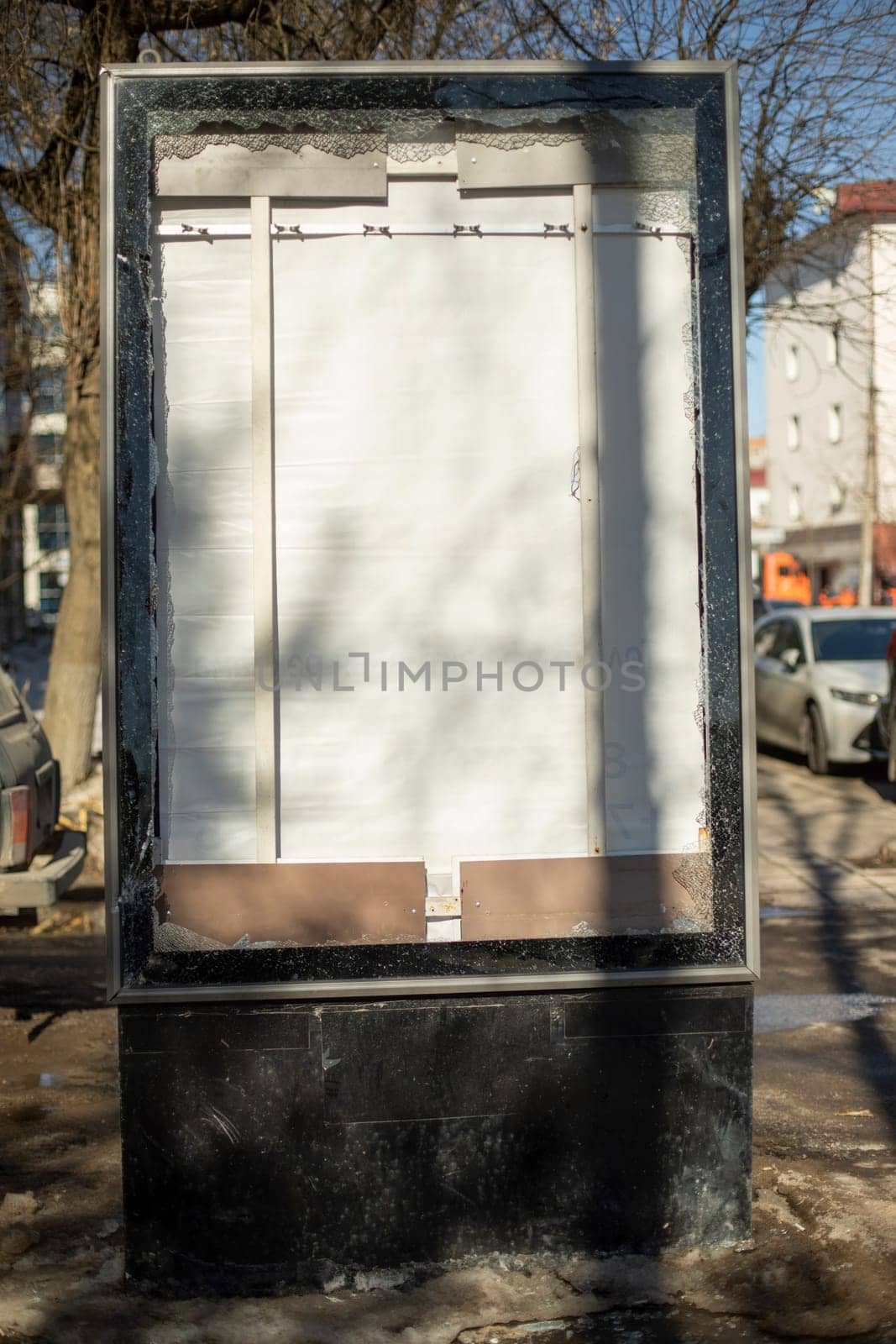 Broken billboard on street. Broken advertising space. Light boxing in city. by OlegKopyov