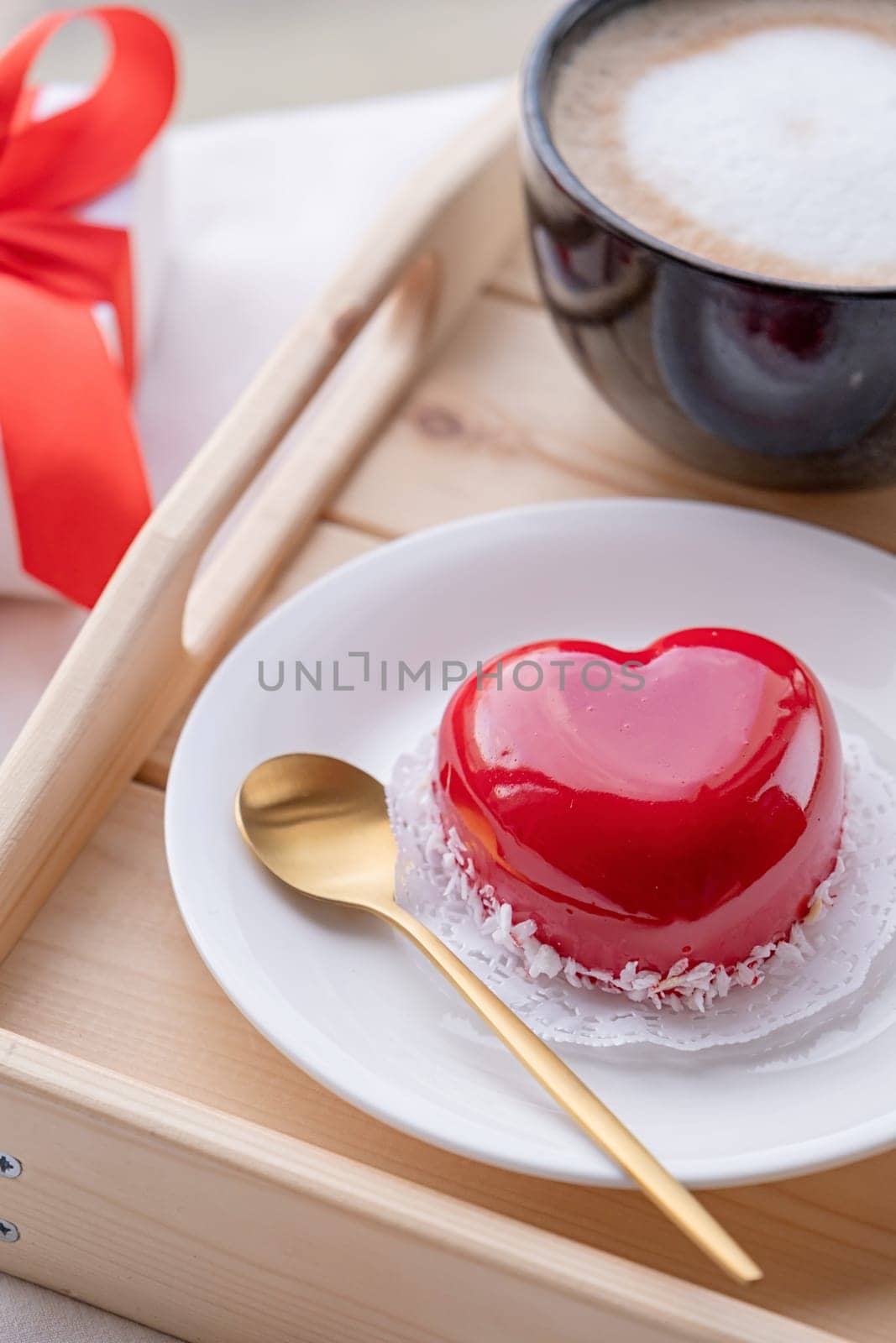 heart shaped glazed valentine cake in bed on wooden tray by Desperada