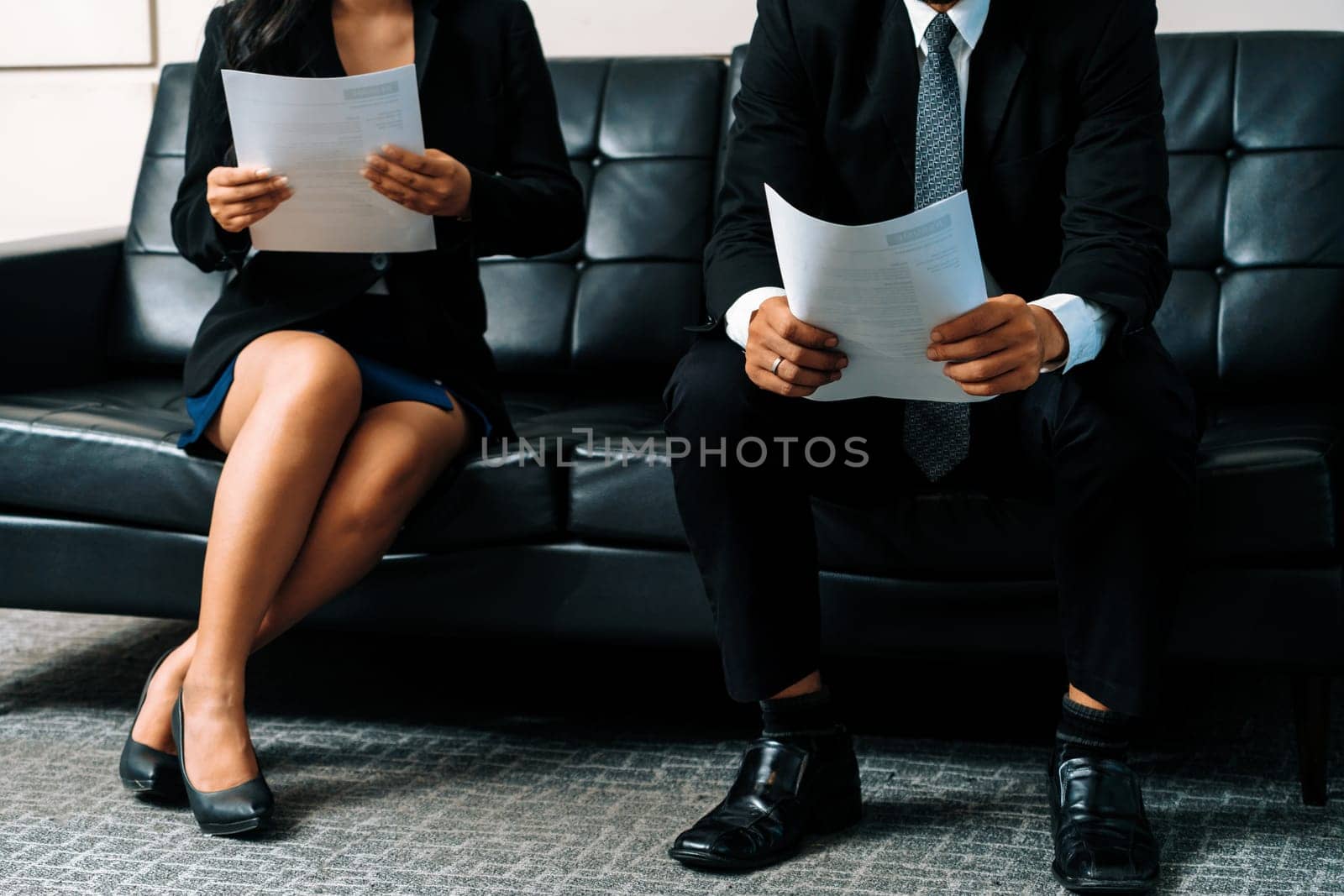 Stressed businessman and businesswoman candidate sit and wait for interview at the company office. Job application, business recruitment and Asian labor hiring concept. uds