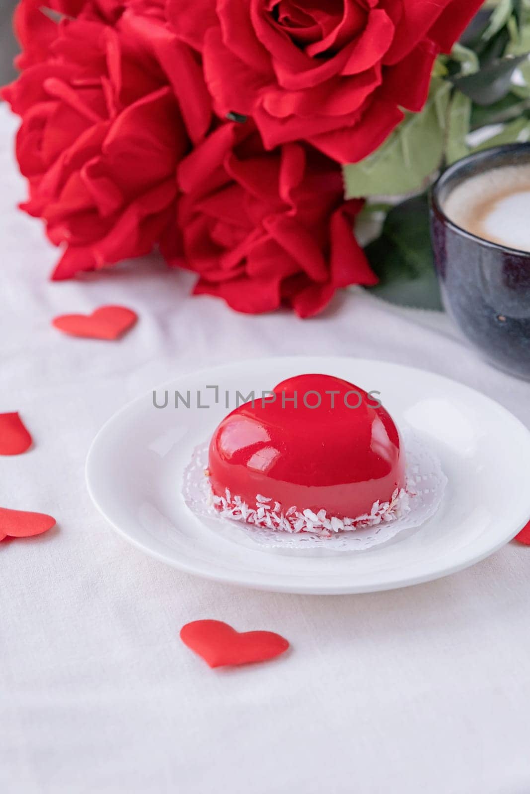 Valentines day. heart shaped glazed valentine cake and flowers in bed