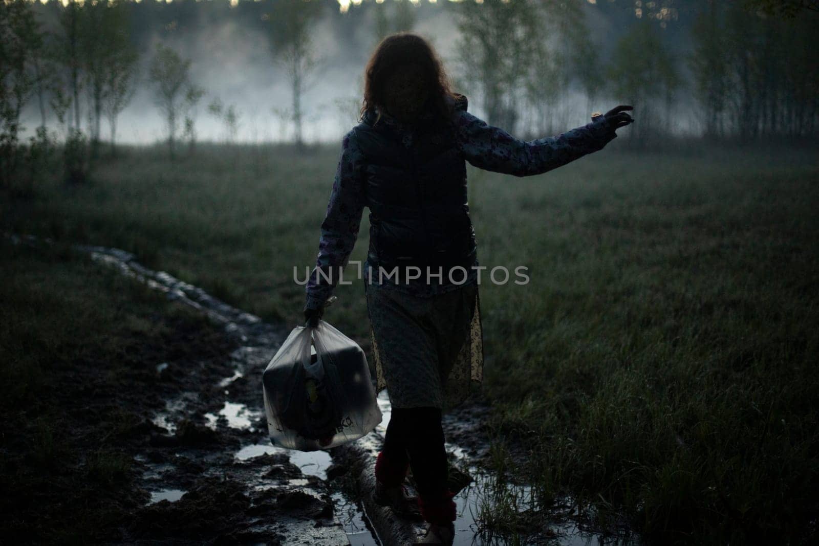 Girl walks in fog in morning. Rest in wild. Fog in swamp. by OlegKopyov