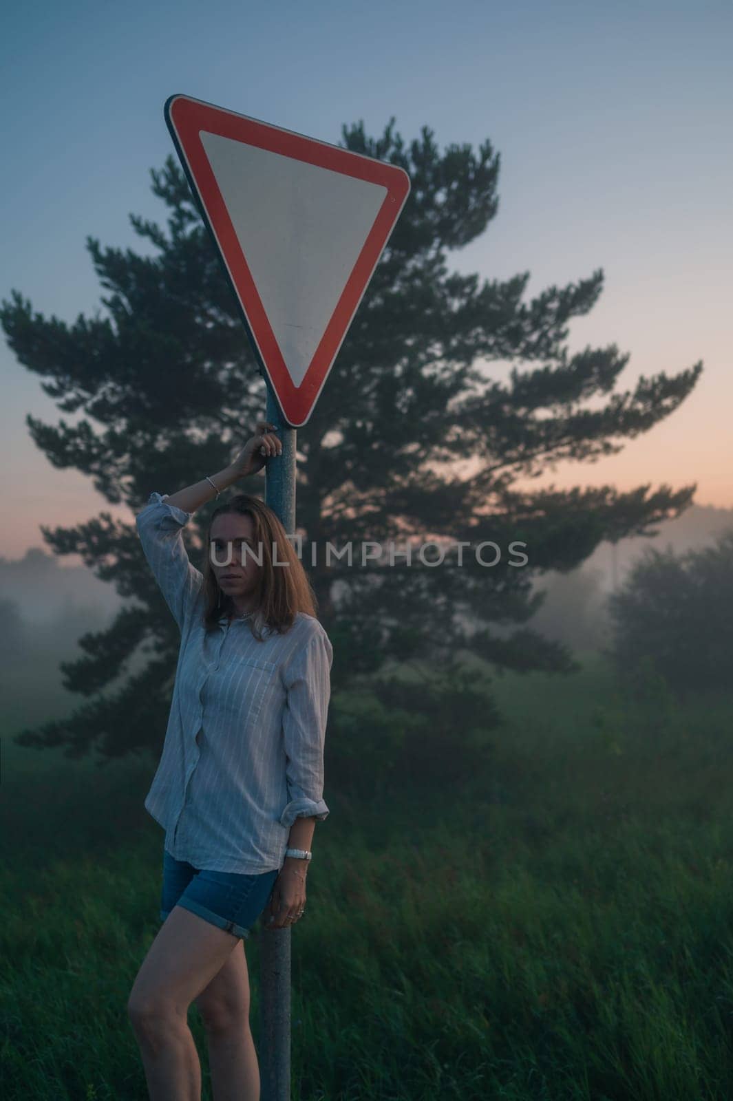 Woman in a field with misty fog