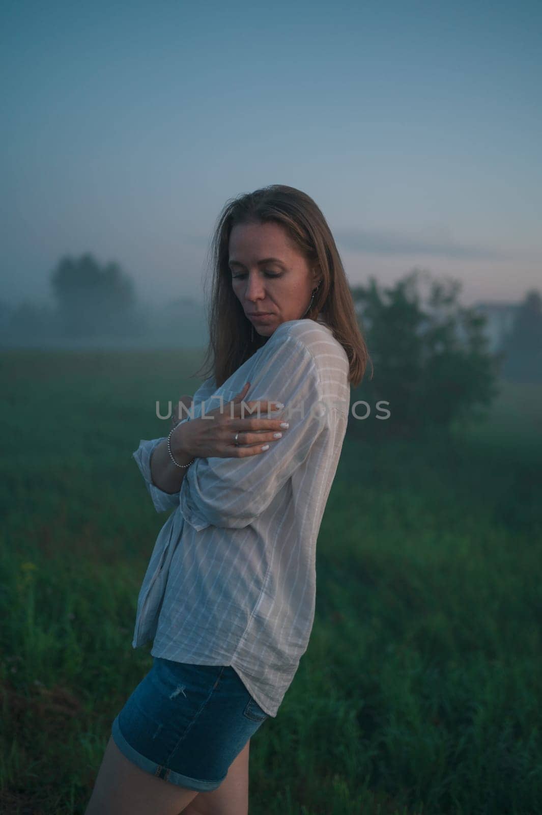 Woman in a field with misty fog