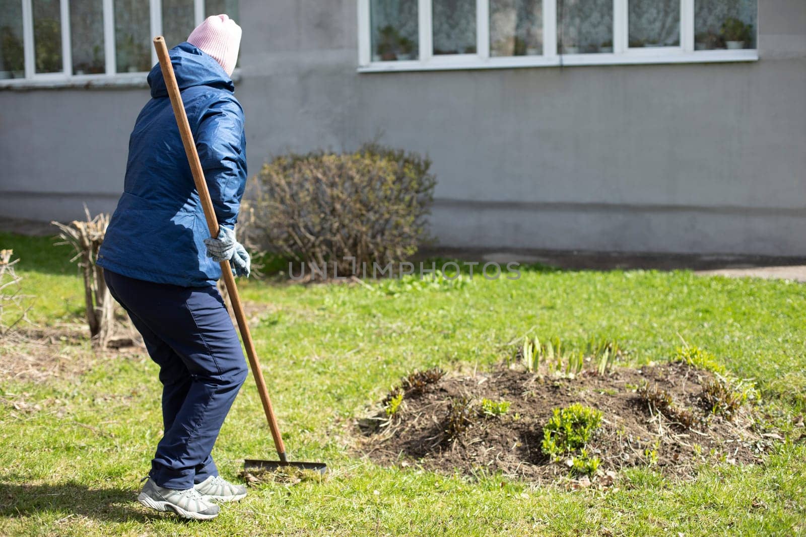 Woman makes flower bed. Gardener is working. Creating beautiful garden. Work in fresh air. Summer landscaping of yard.