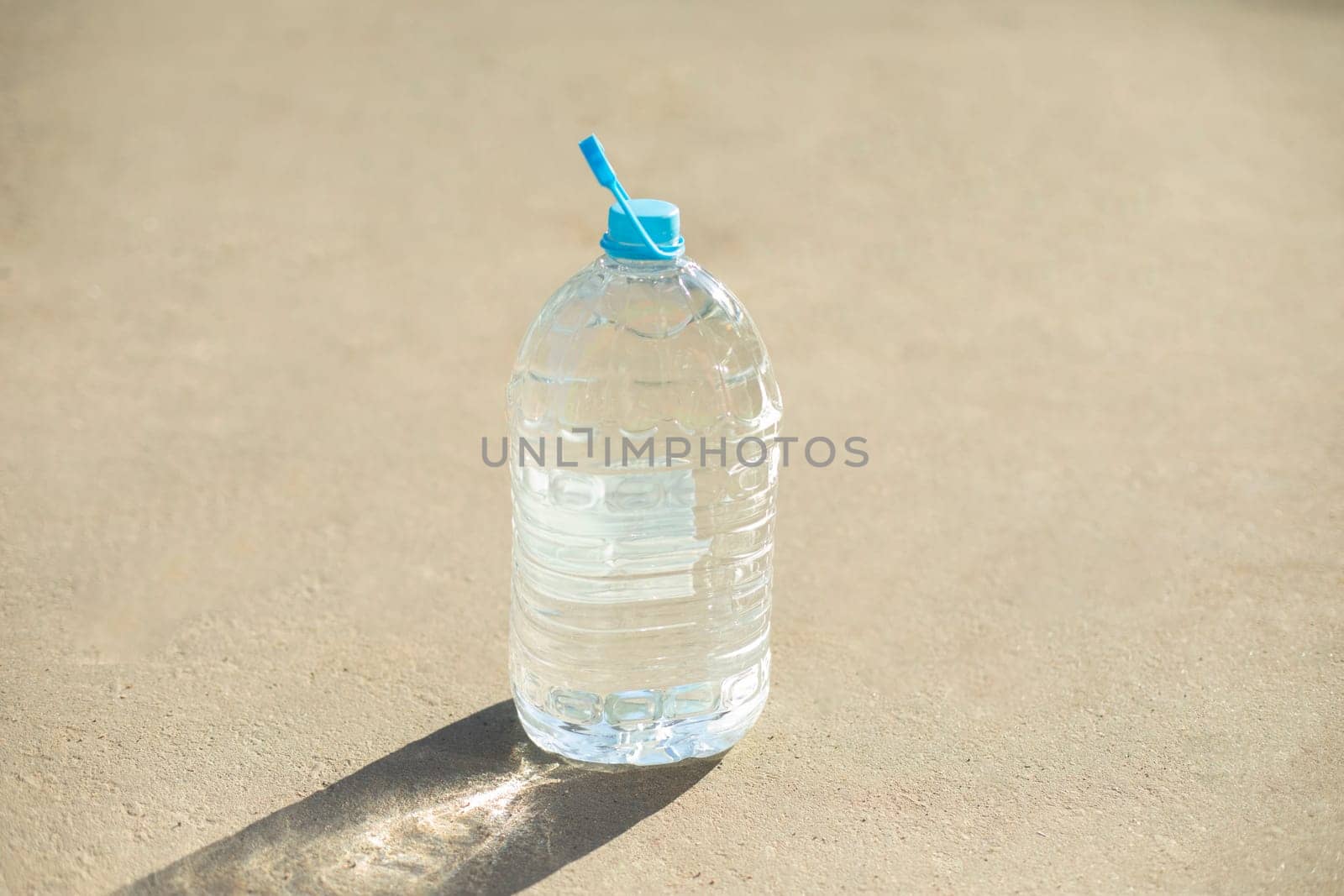 Bottle of water. Empty canister. Plastic water tank. Bottle with handle.