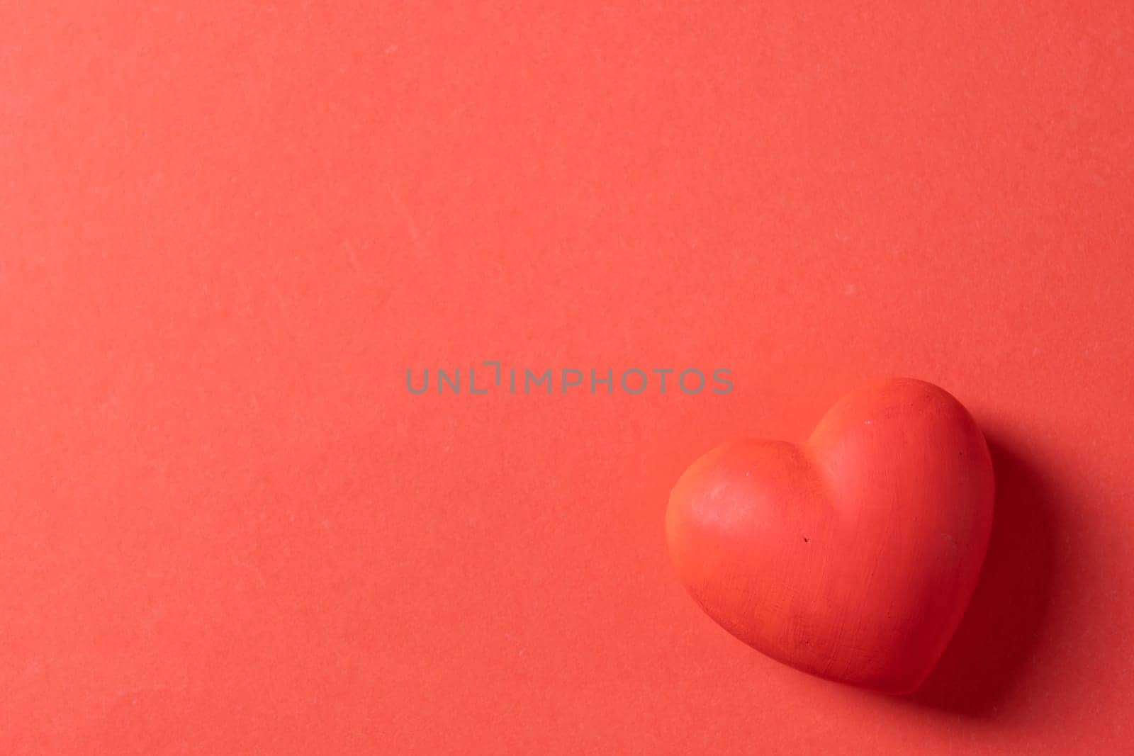 Valentines day. Red heart with copy space isolated on red by Desperada