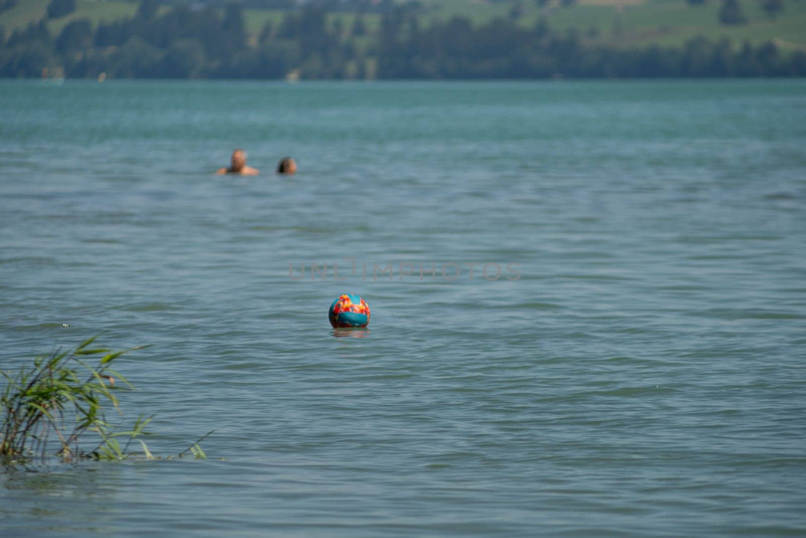 A lonely water ball is floating in a big swimming lake by AllesSuper