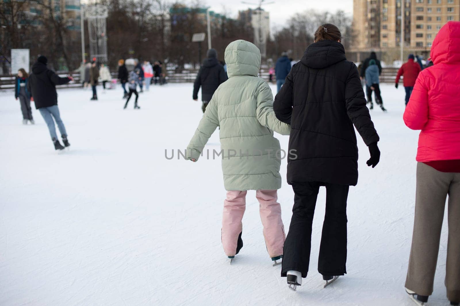 People skate on ice. Winter ice skating. Winter sport. Skates on ice. Details of life during winter holidays.