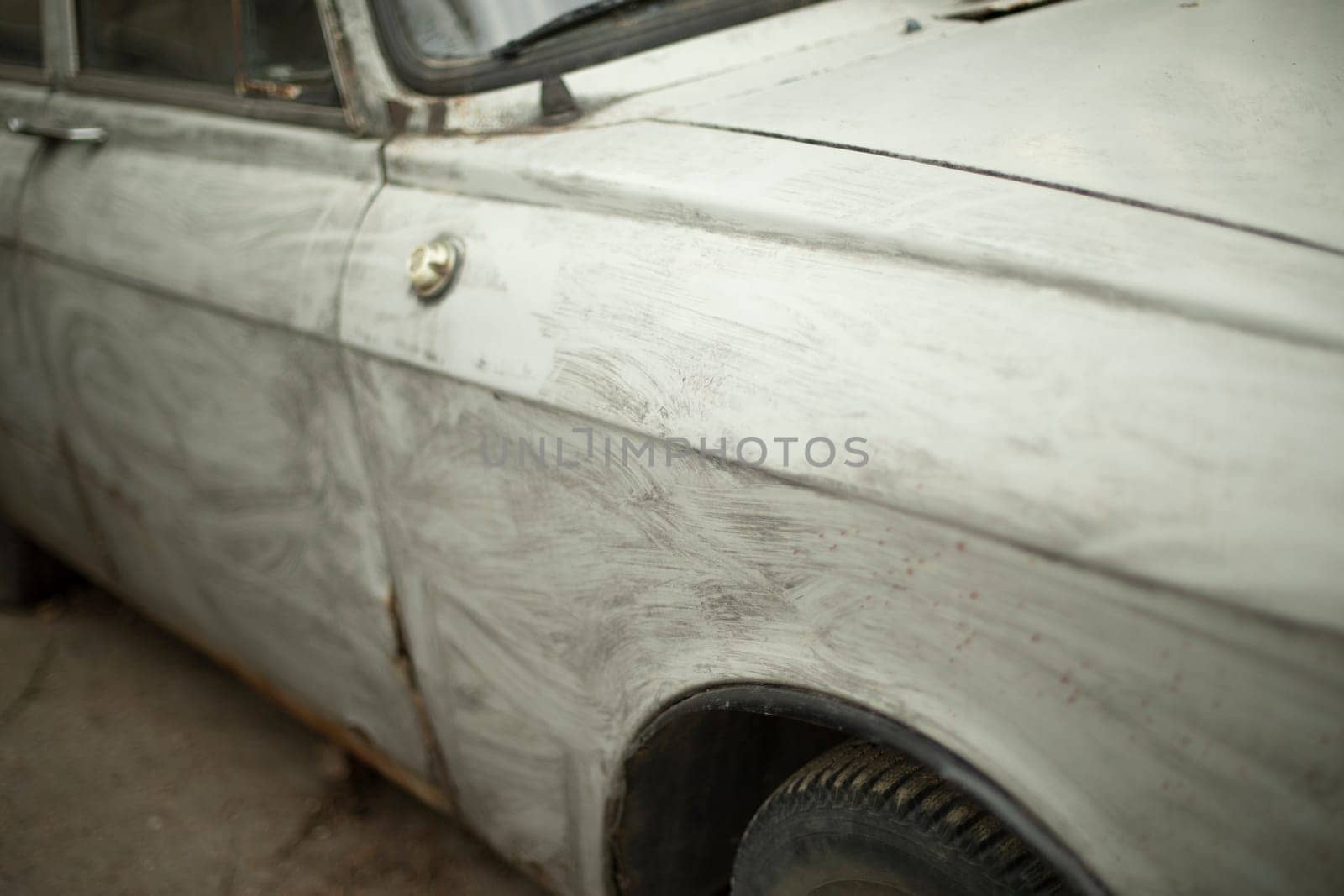 Retro car in gray paint. Transport details. Wing of wheel of machine. Transport in parking lot. by OlegKopyov