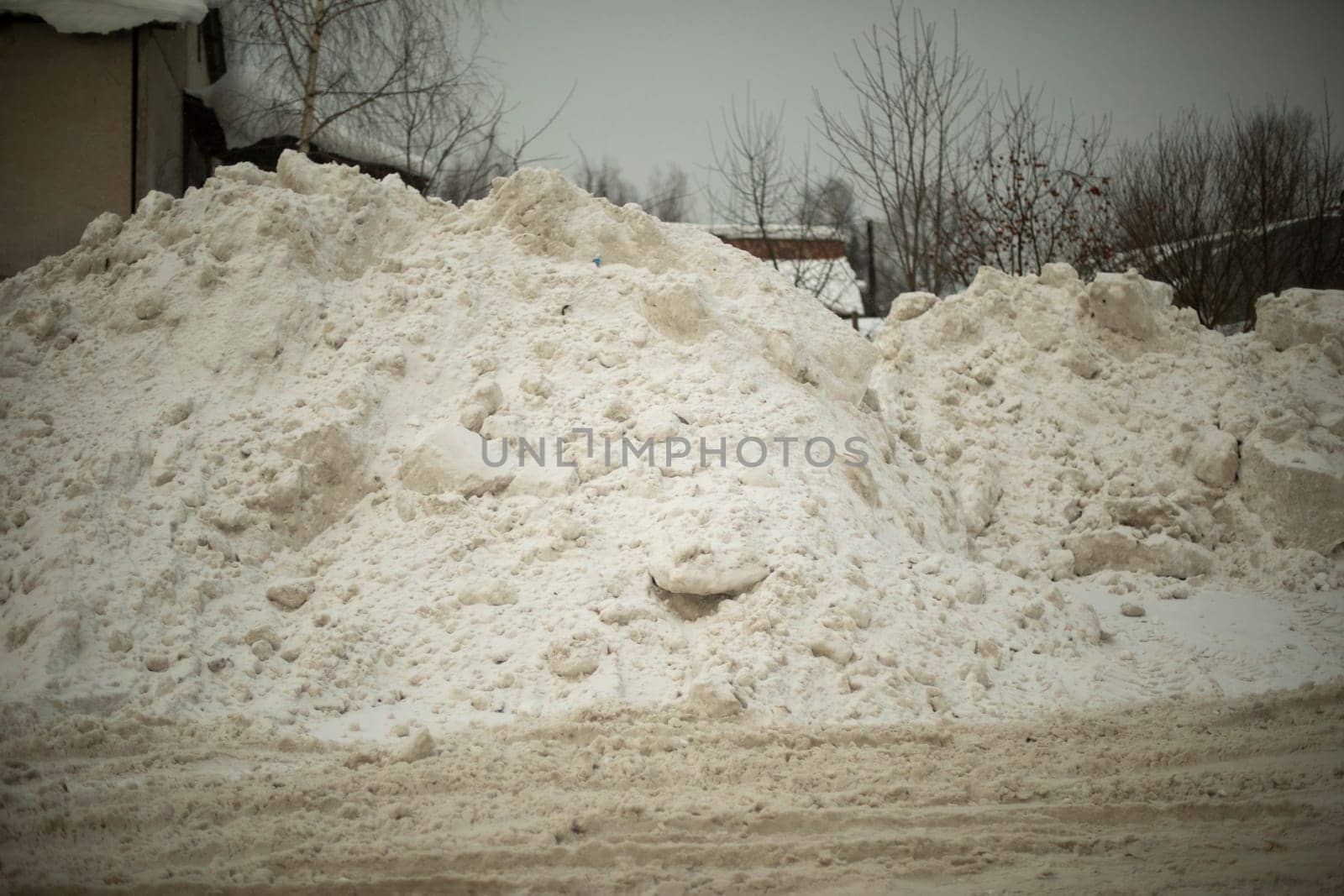 Snow on road. Big mountain of snow on highway. Result of cleaning road. After snowstorm outside.