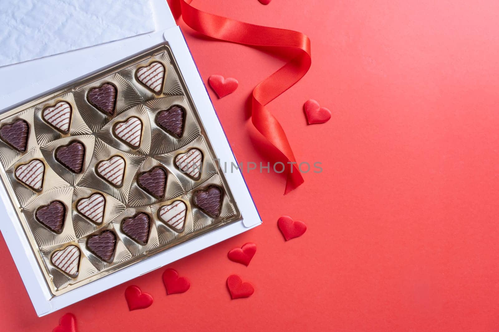 Valentines day. valentine sweet chocolate and red wine on red background