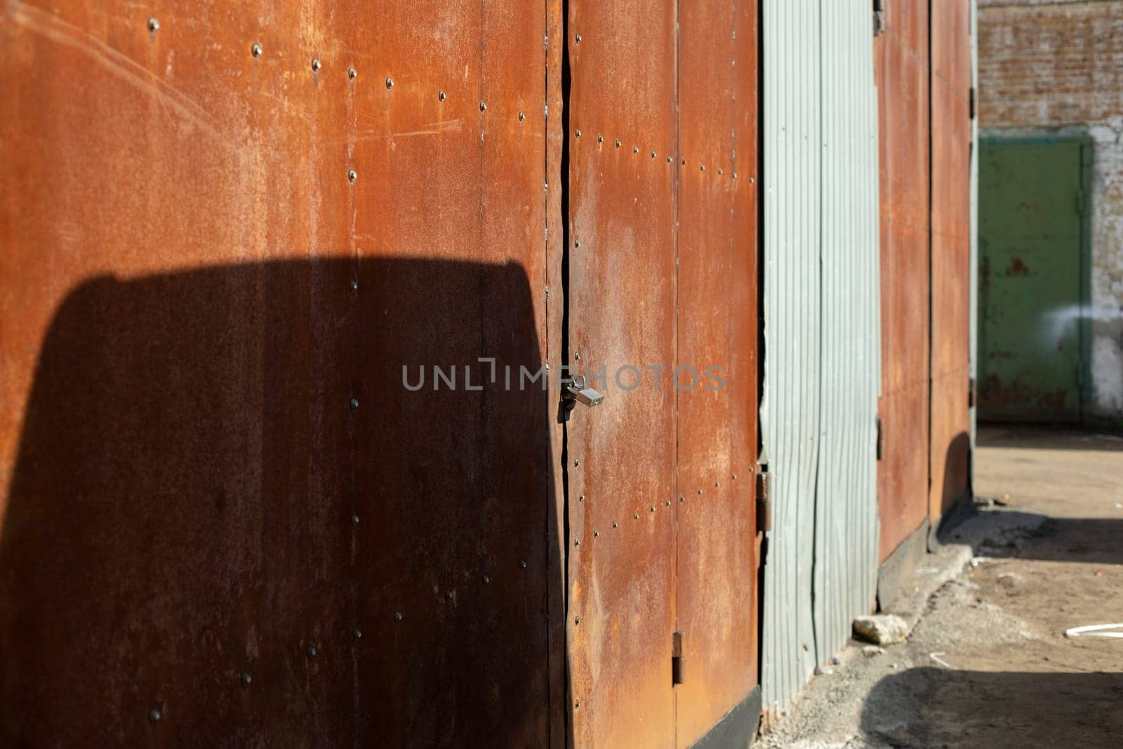 Rusty gates in industrial area. Warehouse details. Steel gates. by OlegKopyov