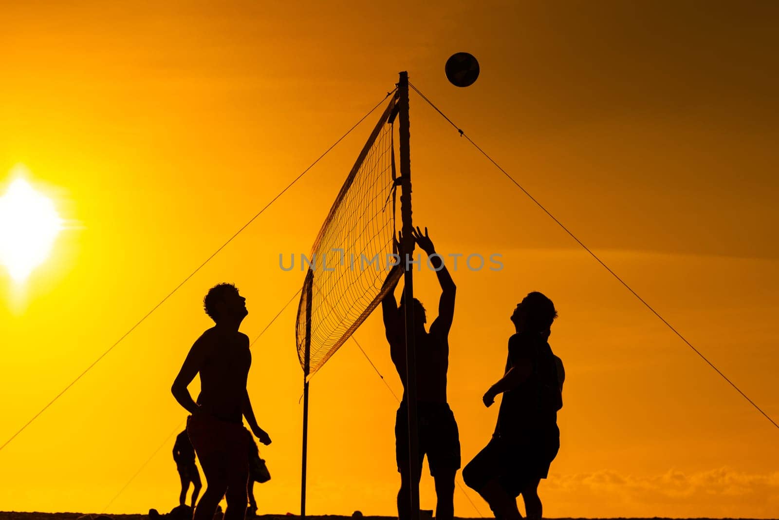 A group of people playing a game of volleyball