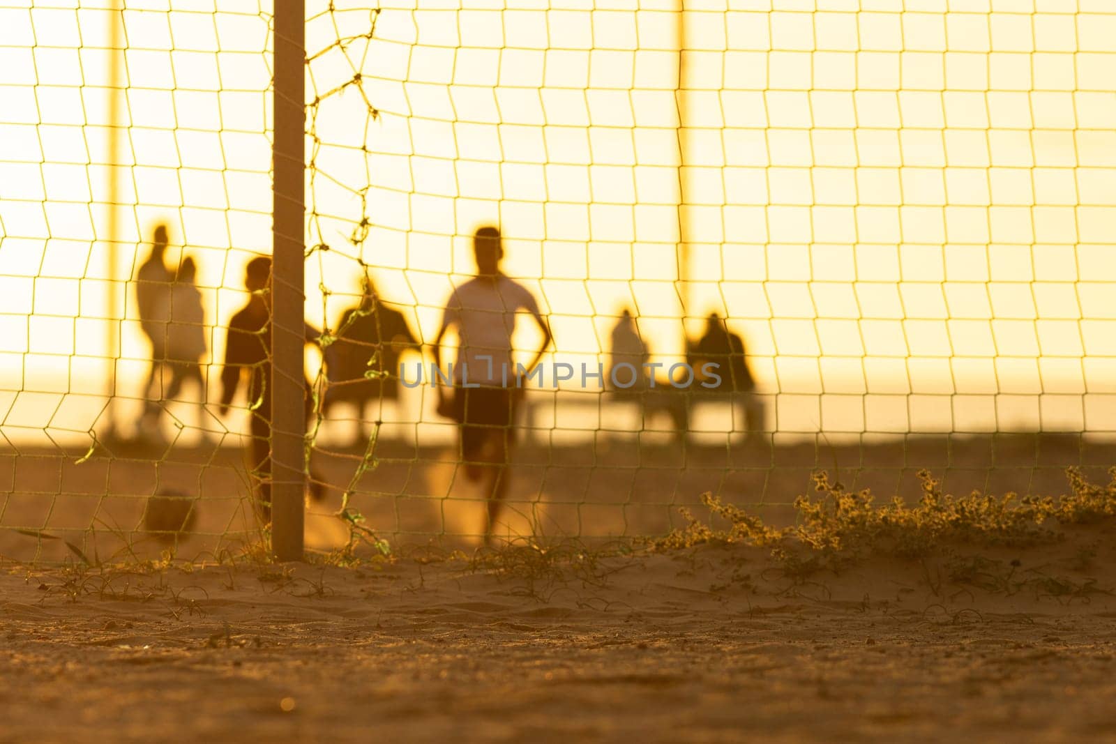 A group of people standing around a soccer goal