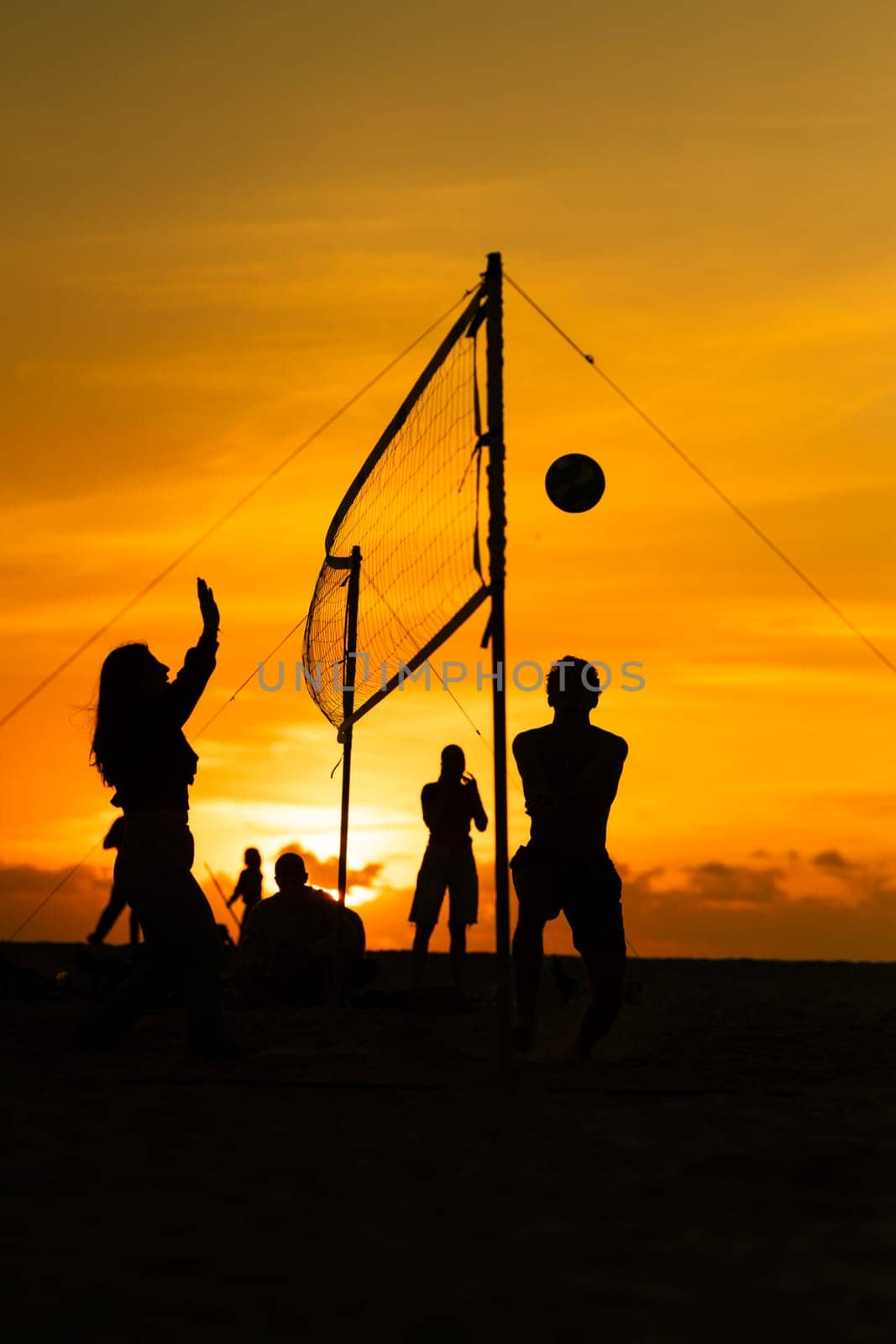 A group of people playing a game of volleyball