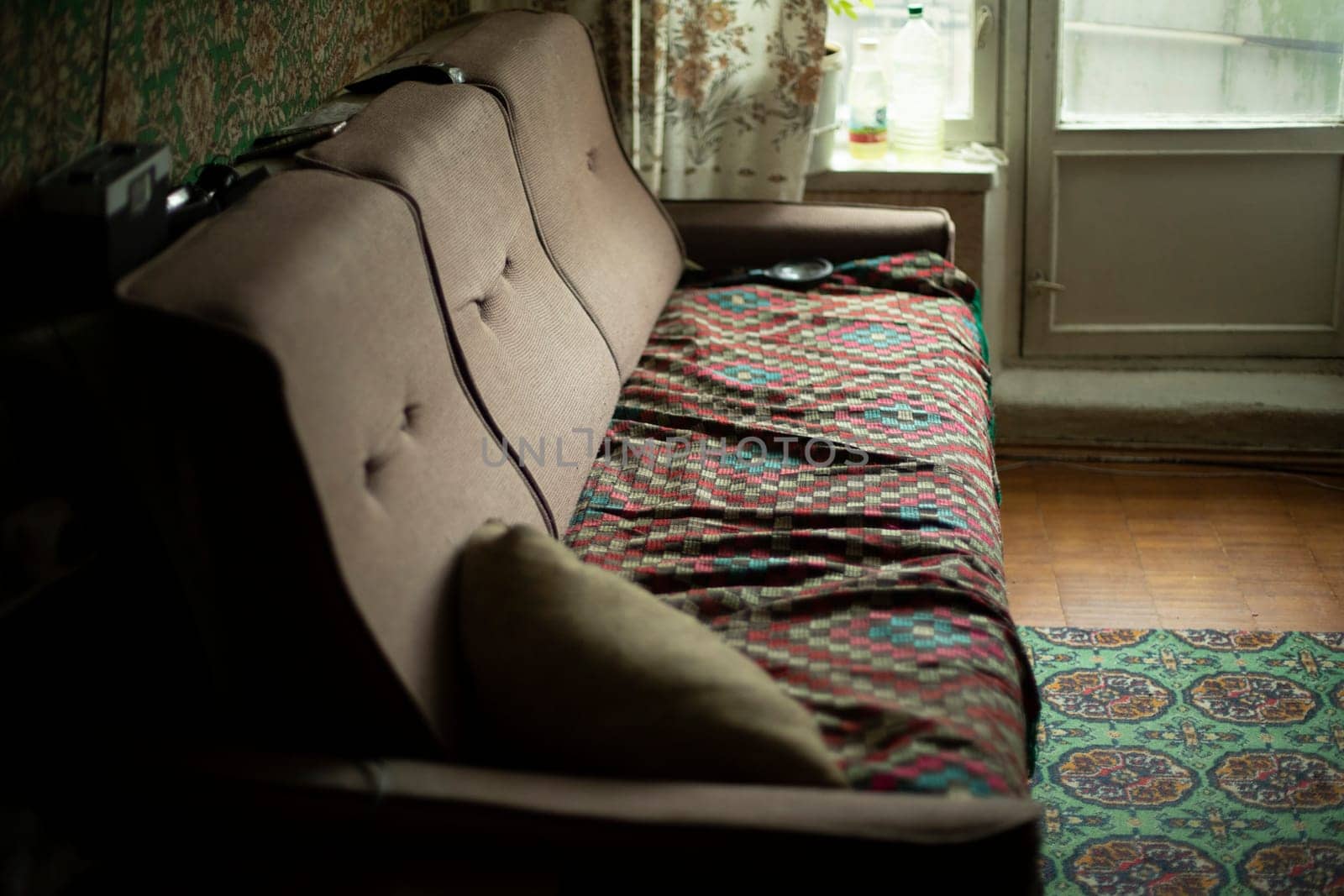 Old sofa in room. Furniture in apartment. by OlegKopyov