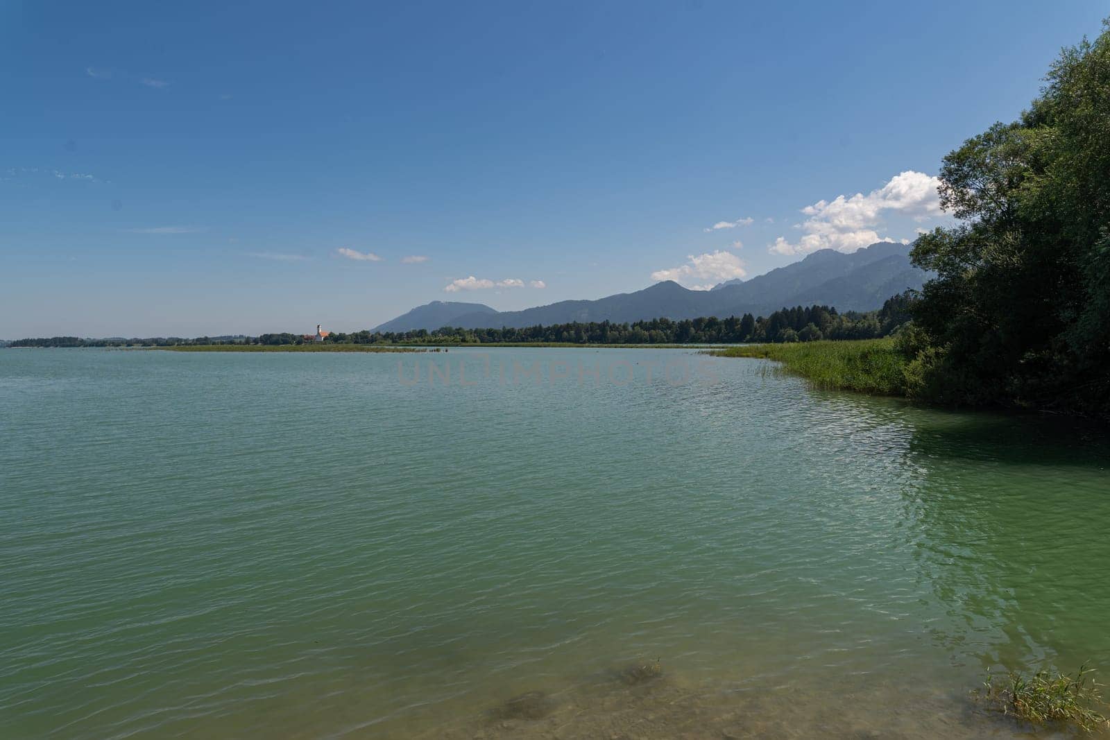 Idyllic view over the Chiemsee with the alp mountains in the background, beautiful summer day by AllesSuper