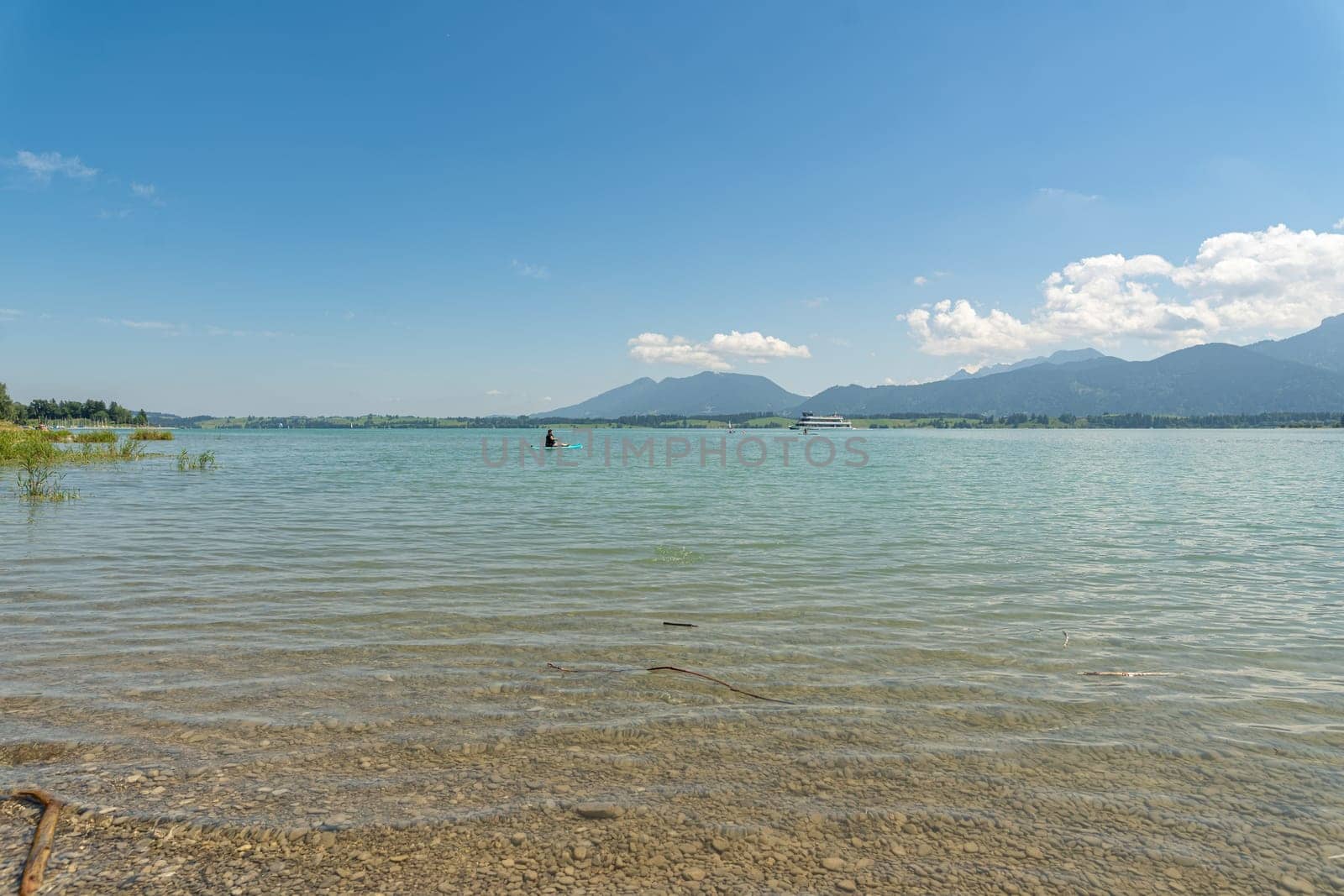 Serene Lake Chiemsee with Boaters and Alpine Backdrop