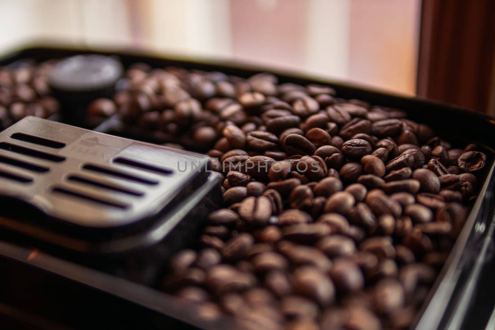 coffee beans in a coffee machine close up with space for inscription. High quality photo