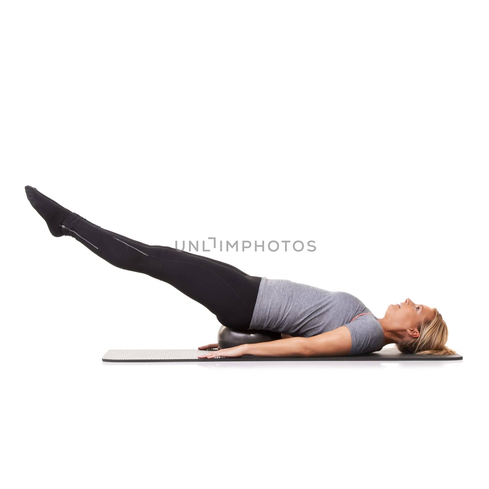 Woman, exercise ball and back health on yoga mat for workout performance, wellness or white background. Female person, gym equipment and pilates fit in studio for mockup space, balance or stretching.