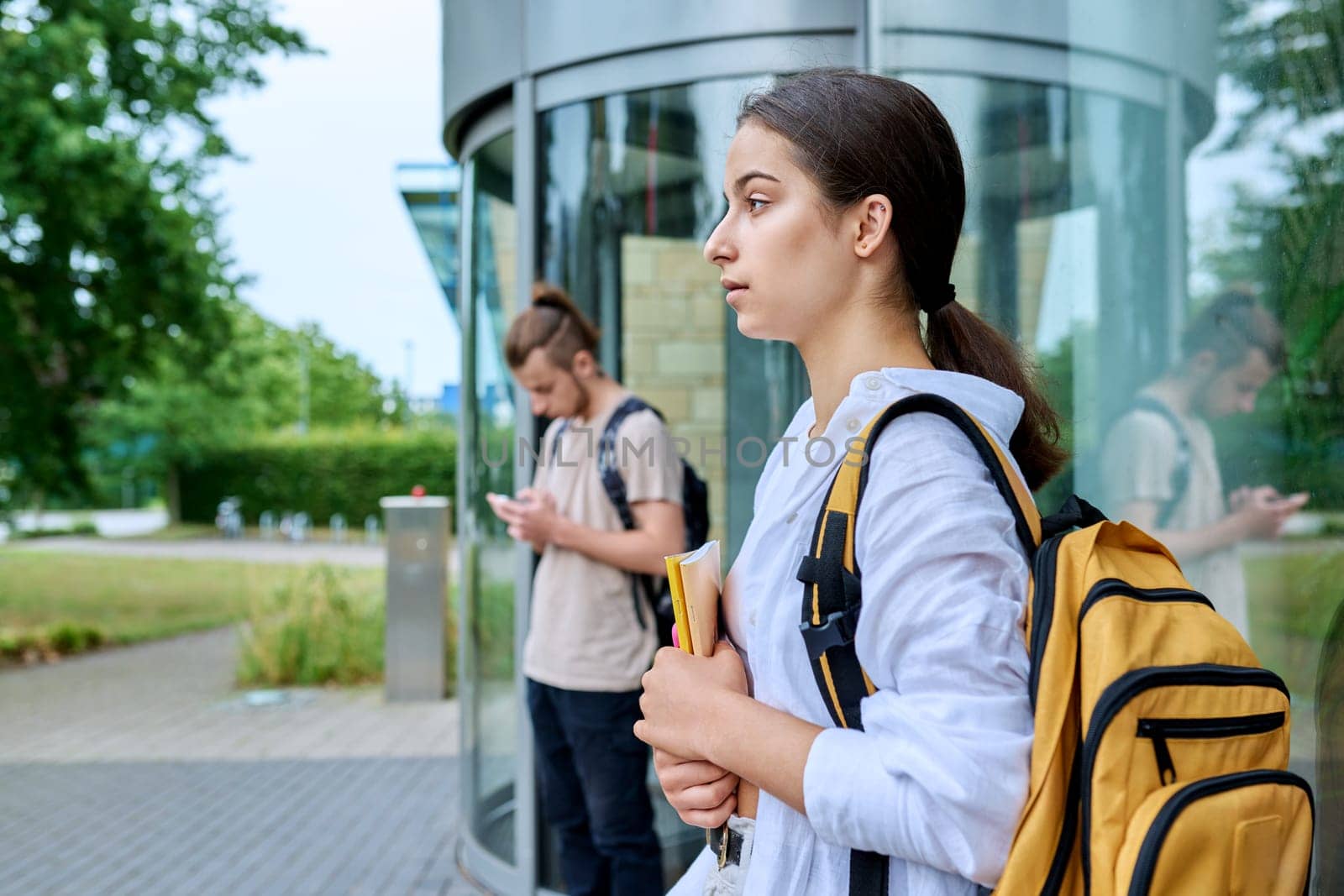 High school student girl looking at camera, outdoor educational building by VH-studio