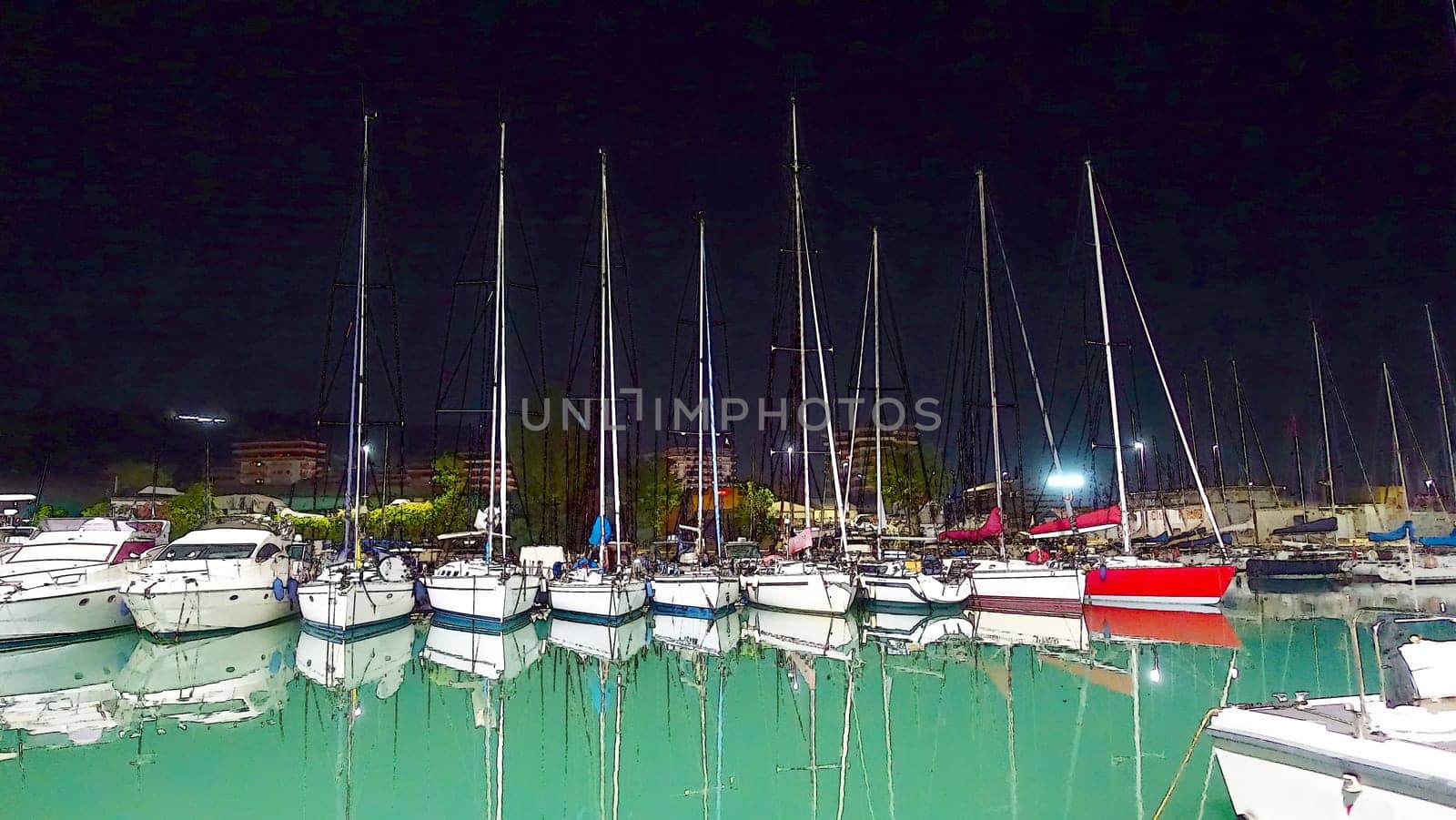 Sailboats docked in a marina on a calm summer night.