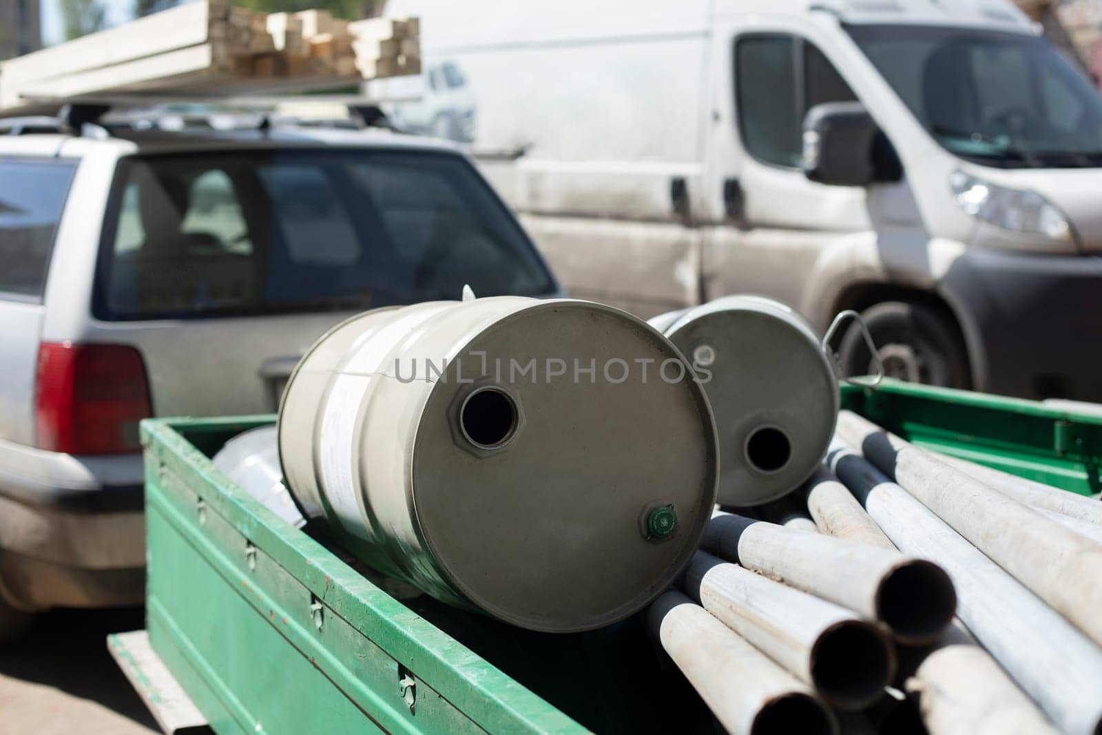 Barrel in trailer. Trailer for car. Pipes and barrel.