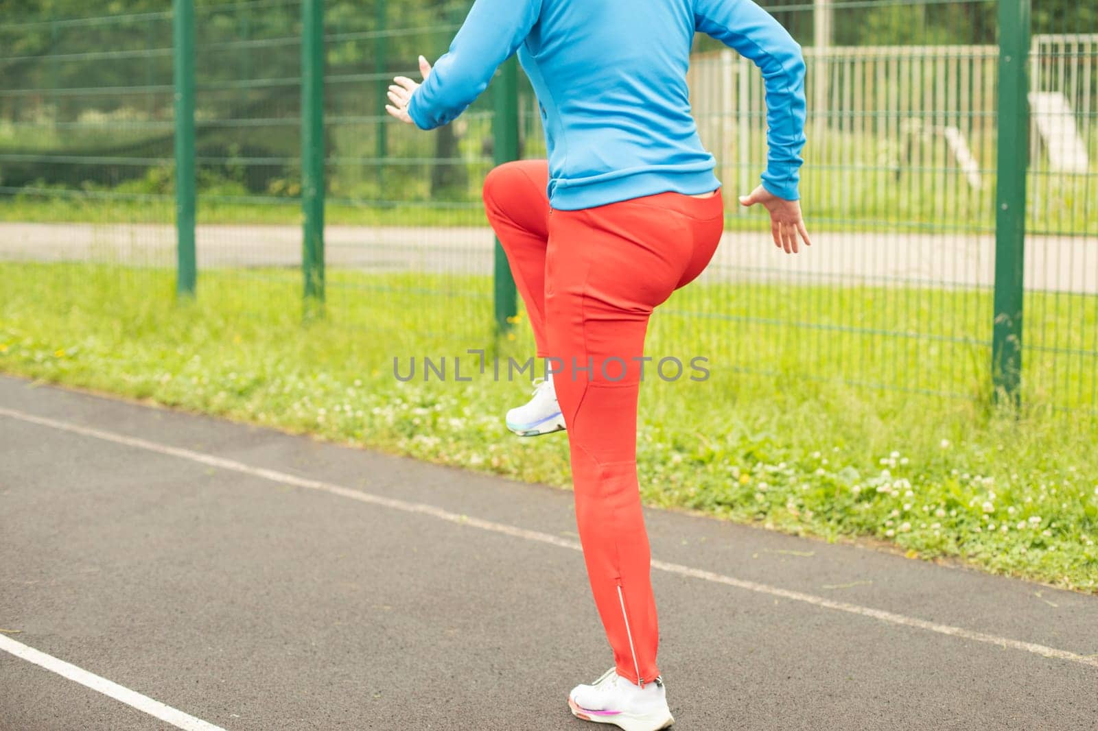 Playing sports on street. Outdoor training. Woman burns calories.