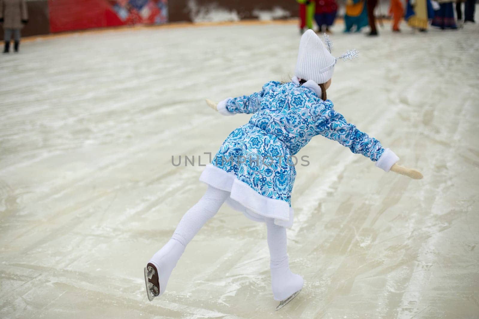 Child on ice. Skater. Sports. Figure skating on ice. Winter holidays.