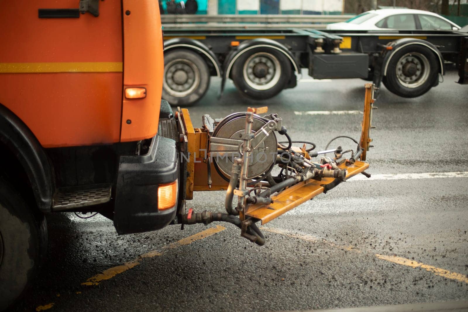 Washing equipment on road. Orange equipment on track. by OlegKopyov