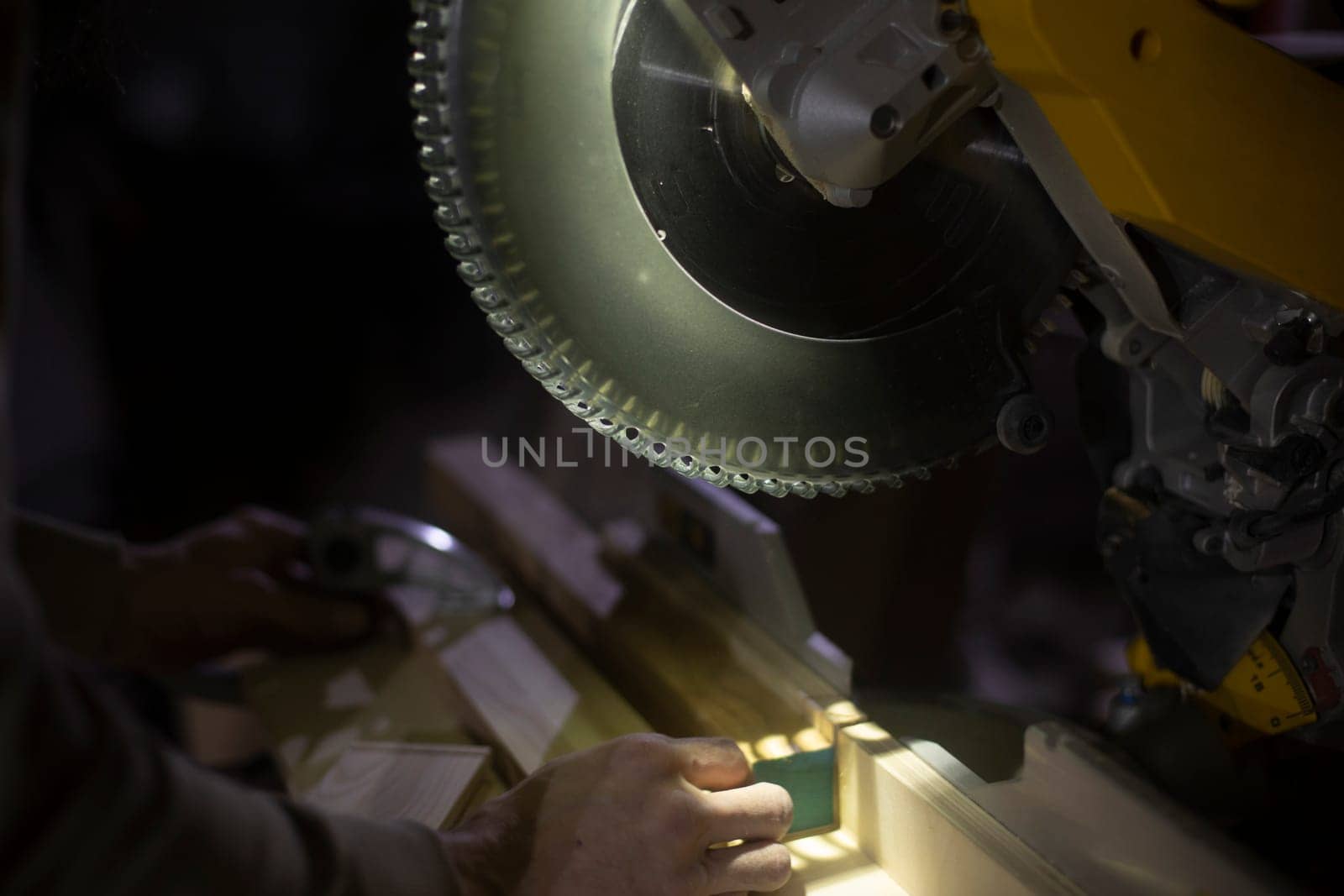 Sawing board with large disc. Details of working with tool on wood. Furniture creation workshop.