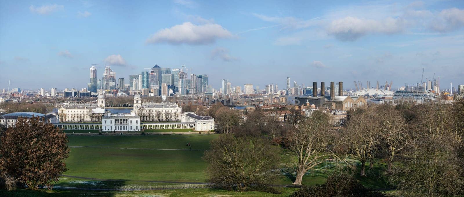 London, United Kingdom - February 02, 2019: Panorama of Canary Wharf skyscrapers, National Maritime museum in front, O2 arena on right side, as seen from Greenwich, during sunny day by Ivanko