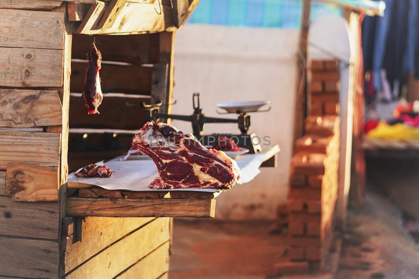 Raw zebu meat shown at local market stall on the street. People are poor in Madagascar, and only few can afford shopping in supermarket, markets near road are preferred for buying food