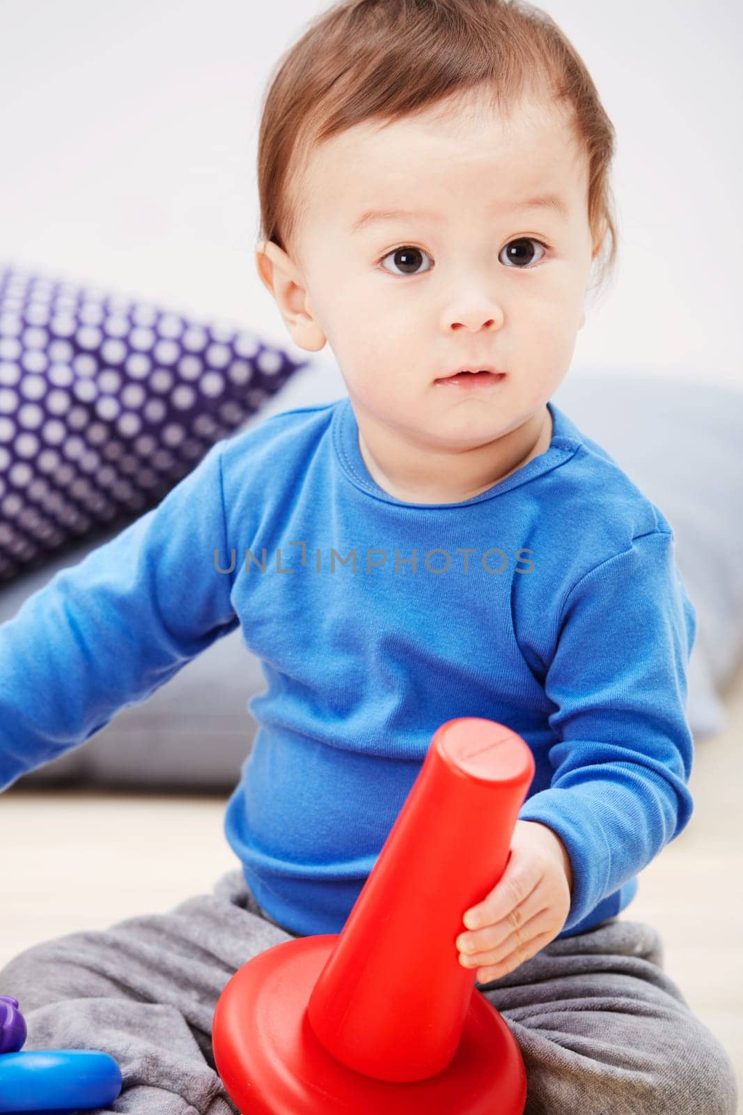 Baby, toys and playing on carpet in home or development, learning or education. Boy, kid and floor for game in lounge or puzzle progress or cognitive interest for coordination, support or sensory fun.