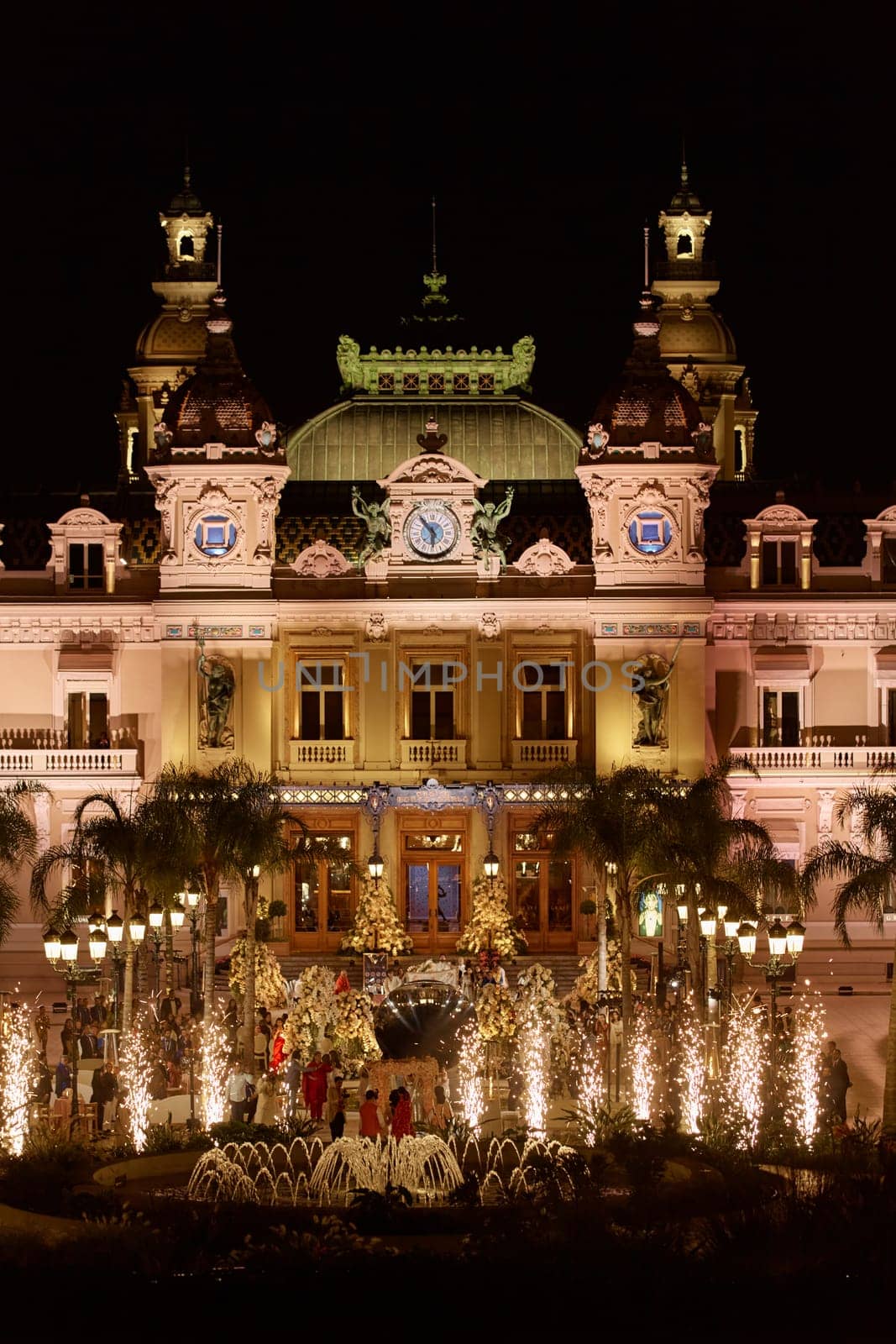 Monaco, Monte-Carlo, 12 November 2022: The famous Casino Monte-Carlo is at night, attraction night illumination, luxury cars, players, tourists, splashes of fountain. High quality photo