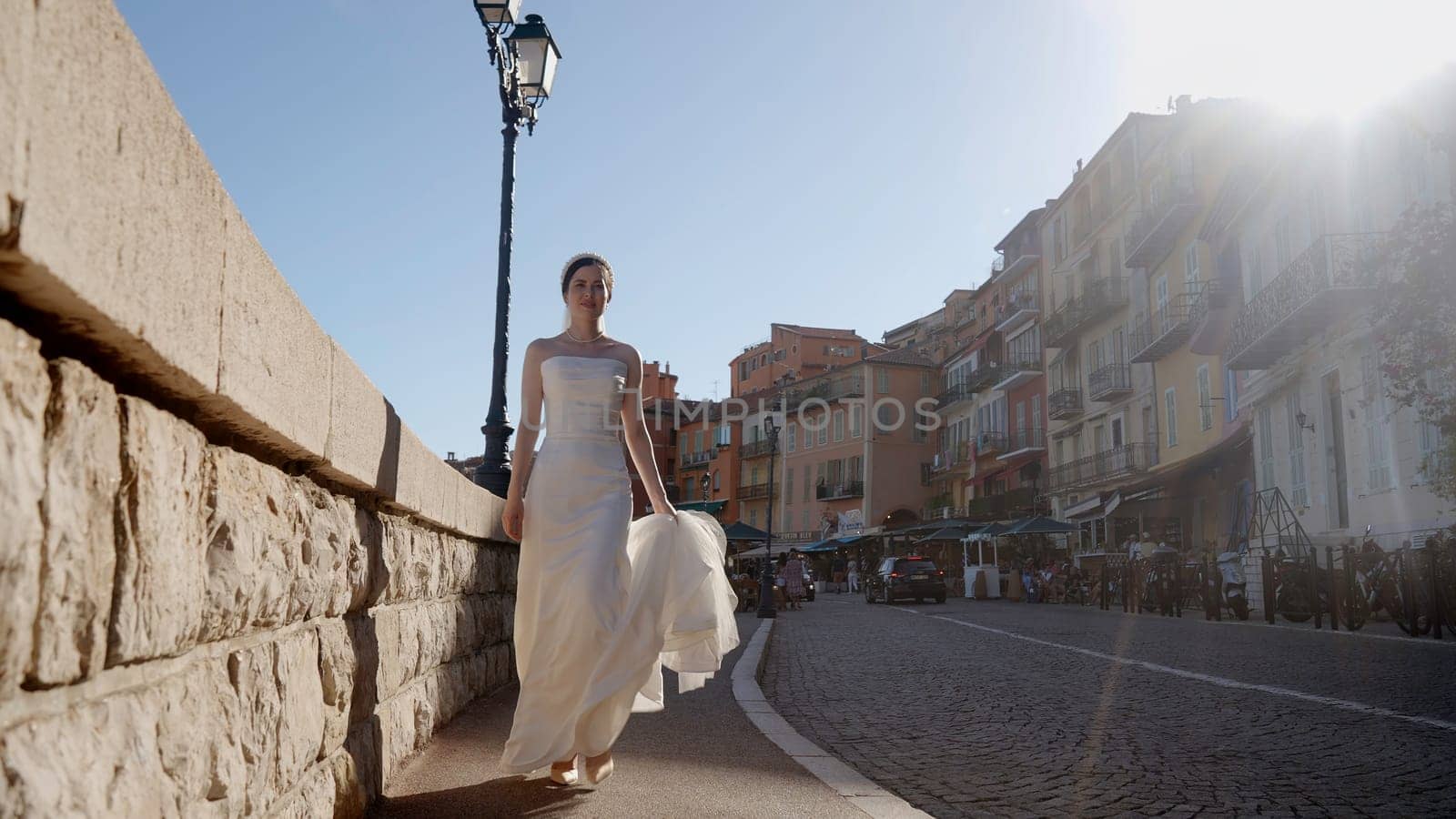 Newlyweds walking near the fountains. Action. Beautiful people together with a bride in a white tight dress and a man in tourist places near the river with parked ships. High quality 4k footage