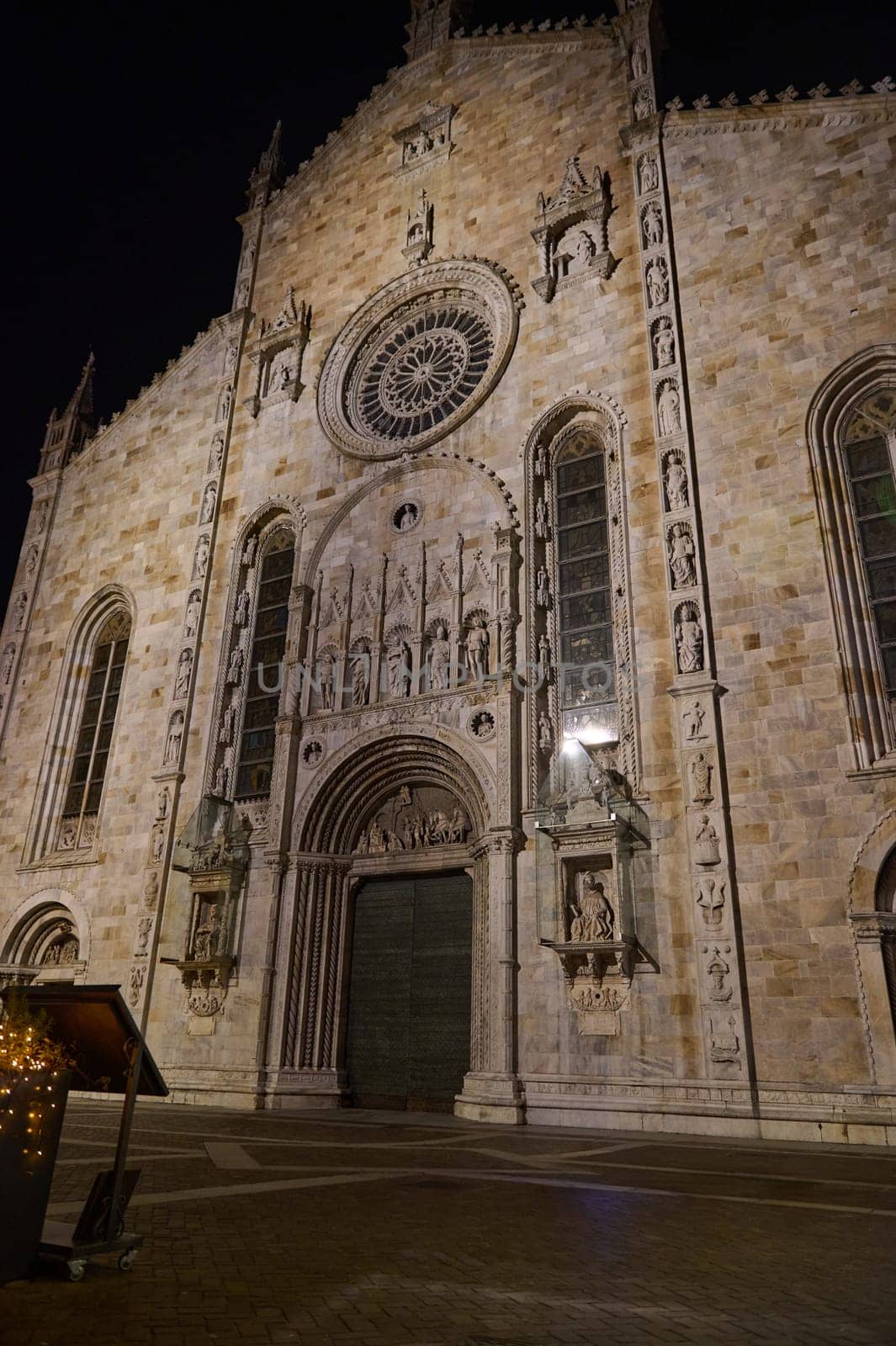 Como city, Lombardy, Italy. December 2023: View from the bottom of facades of Santa Maria Assunta Cathedral in Como city, shot in the night time. Medieval Como cathedral on Lake Como in Italy Lombardy