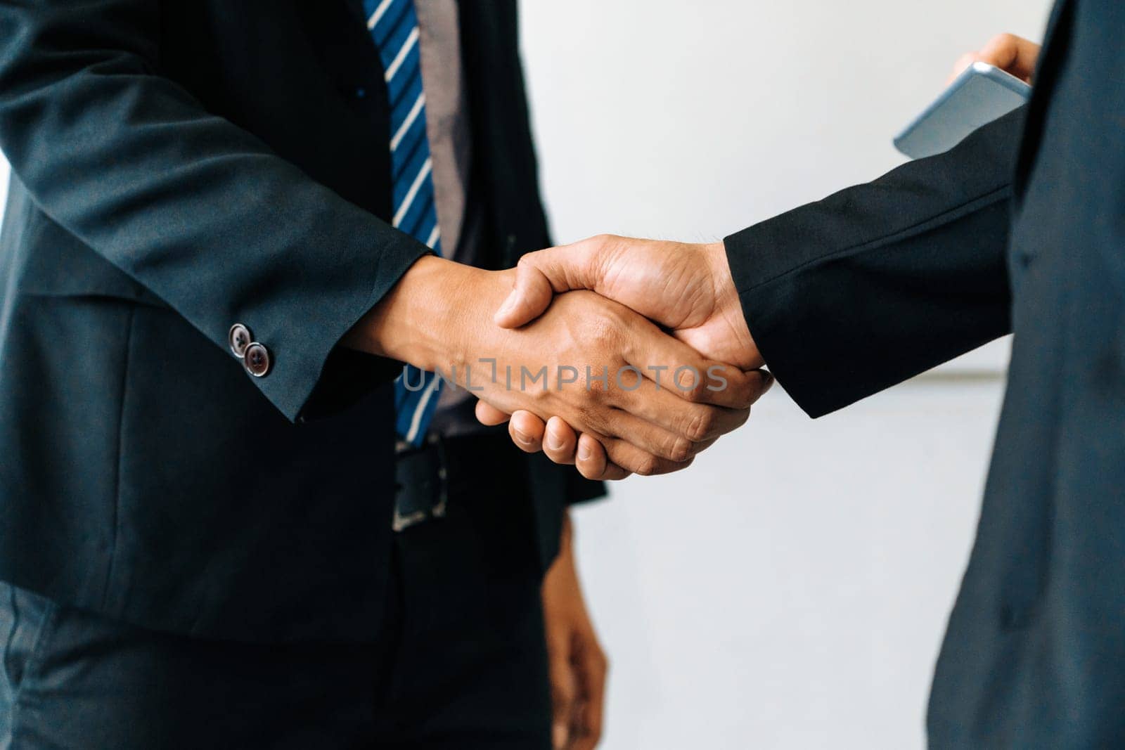 Business people agreement concept. Businessman do handshake with another businessman in the office meeting room. uds