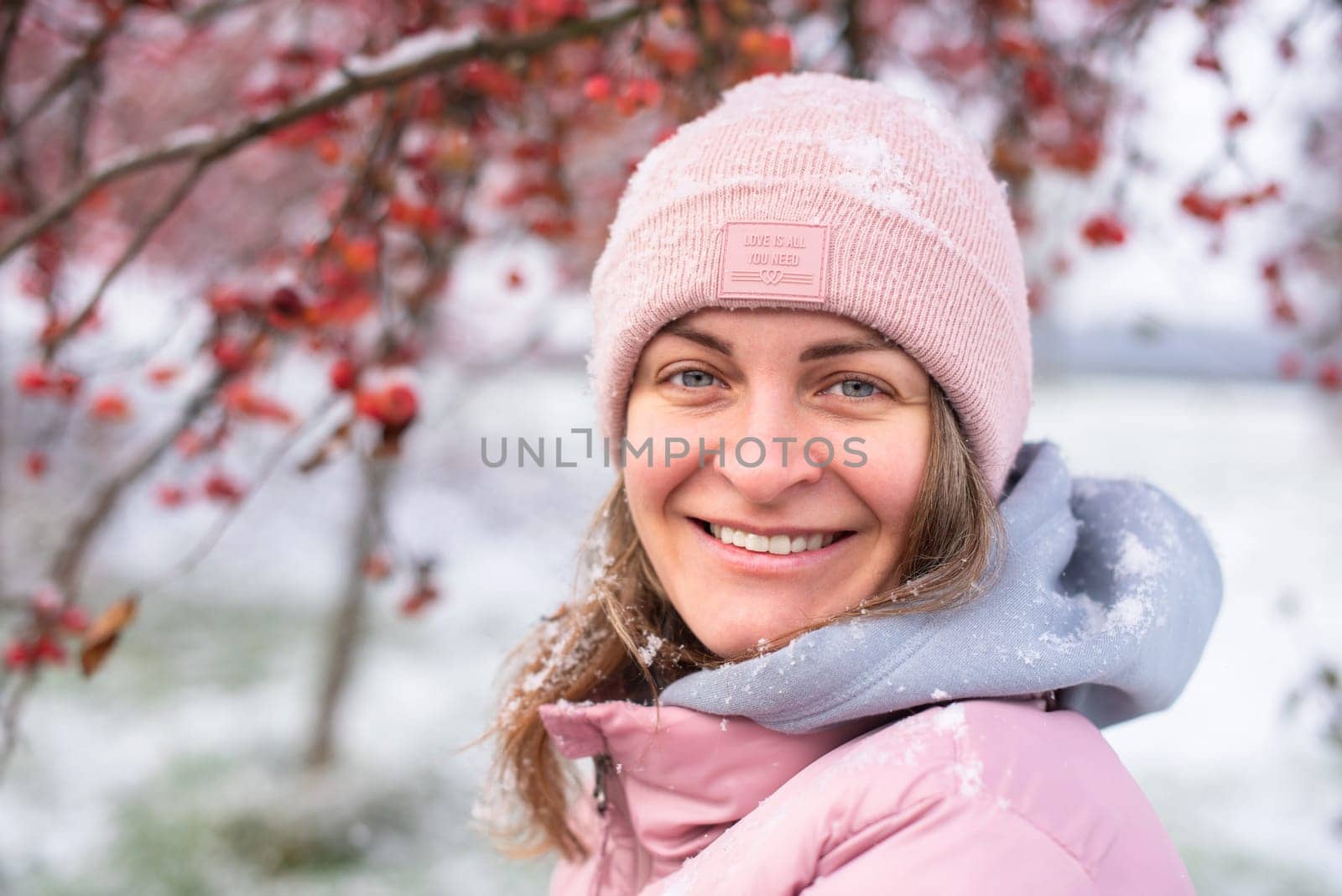 Winter Elegance: Portrait of a Beautiful Girl in a Snowy European Village. Winter lifestyle portrait of cheerful pretty girl. Smiling and having fun in the snow park. Snowflakes falling down. Christmas Radiance: Capturing Winter Elegance in the Snowy Ambiance of a European Village by Andrii_Ko