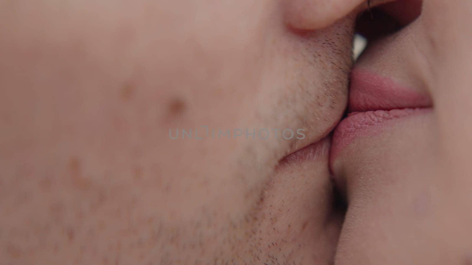 Couple gently kissing close up. Action. Male and female kissing lips, concept of love and romance. by Mediawhalestock