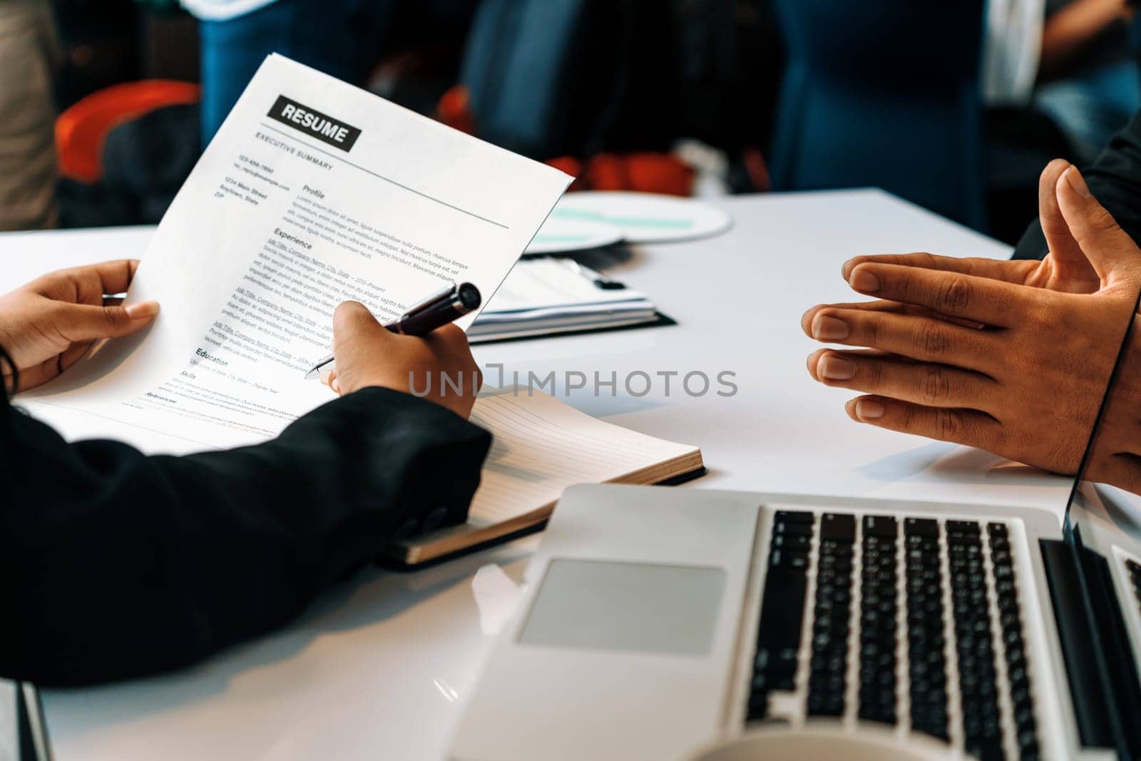 Human resources department manager reads CV resume document of an employee candidate at interview room. Job application, recruit and labor hiring concept. uds