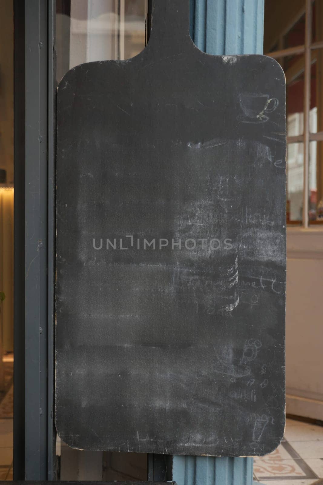 Empty wooden blackboard mockup standing outdoors in front of cafe by towfiq007